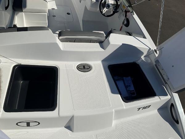 2025 Tahoe T18 boat interior with storage compartments and steering wheel.