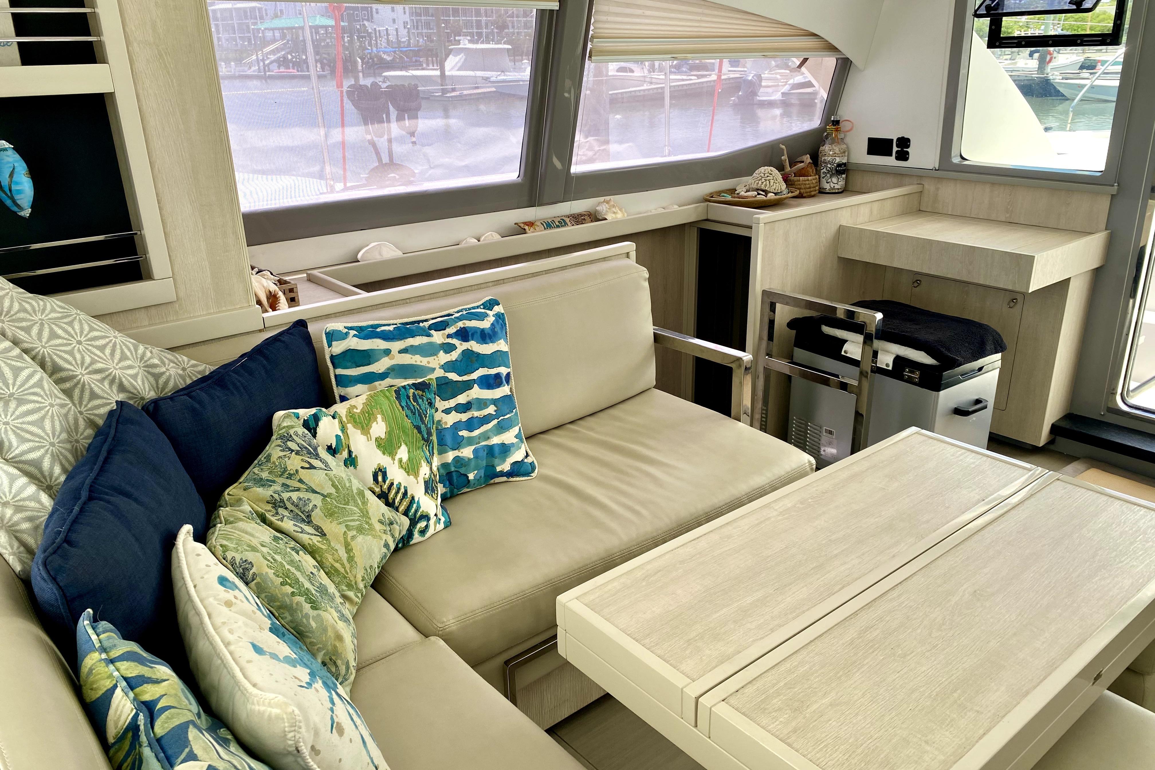 Luxurious interior of a 2017 Leopard 40 catamaran with plush seating and vibrant cushions.