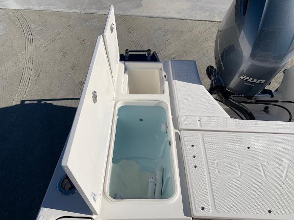 2024 Robalo 226 Cayman boat with open storage compartments and 200 HP engine.