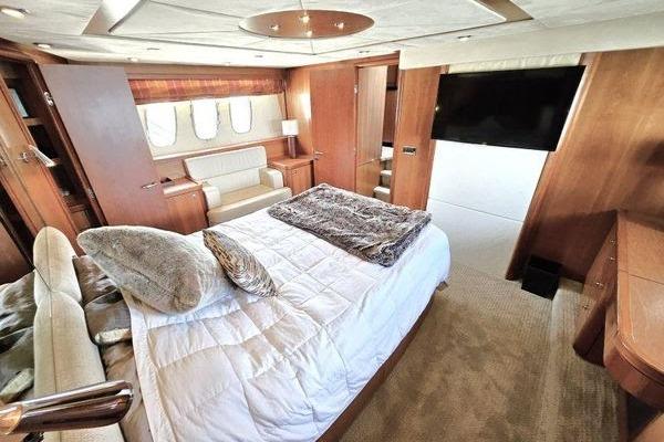 Luxurious bedroom interior of 2005 Sunseeker Manhattan 66 yacht with elegant furnishings.