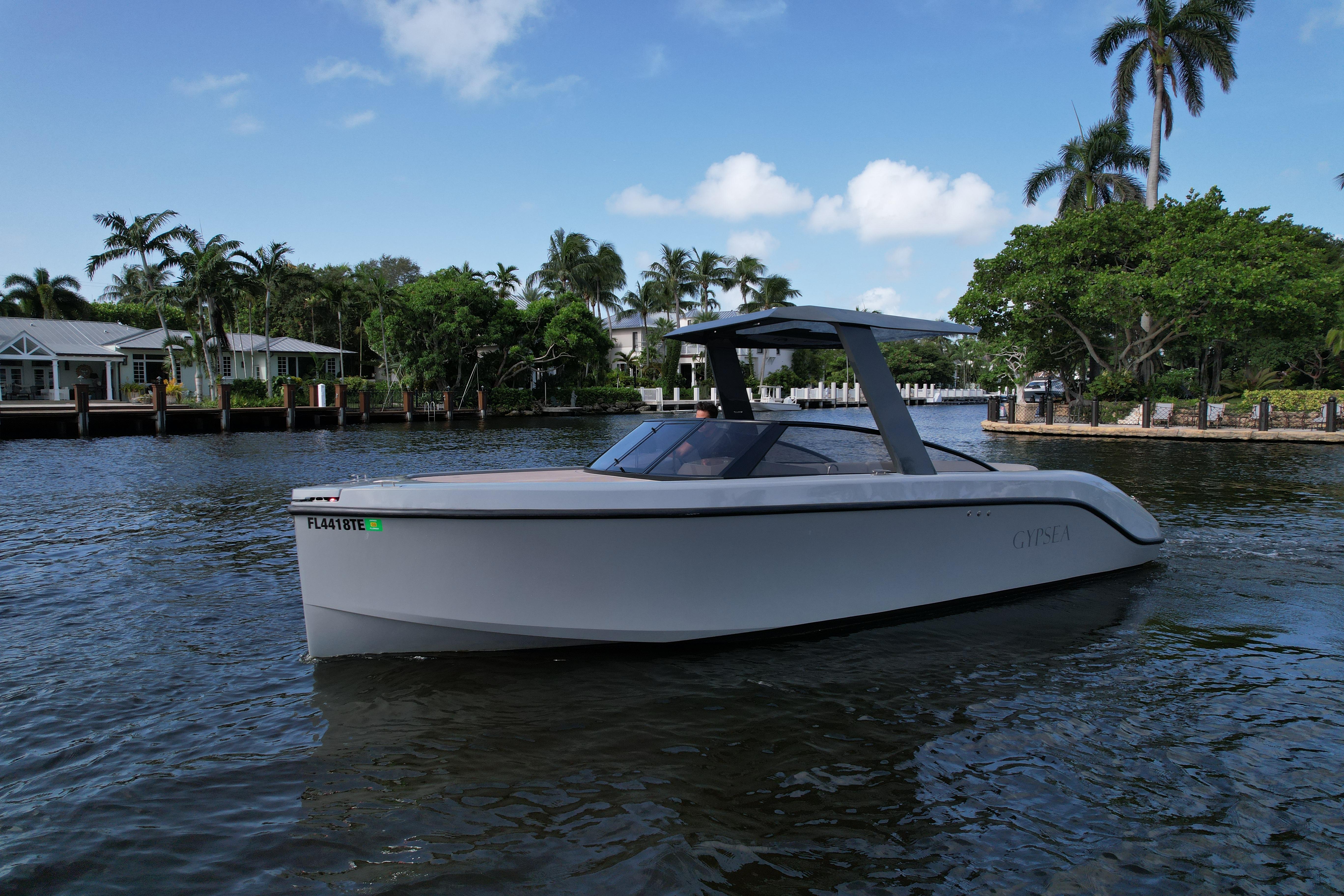 Modern 2021 Rand Leisure boat cruising on a scenic waterway with palm trees.