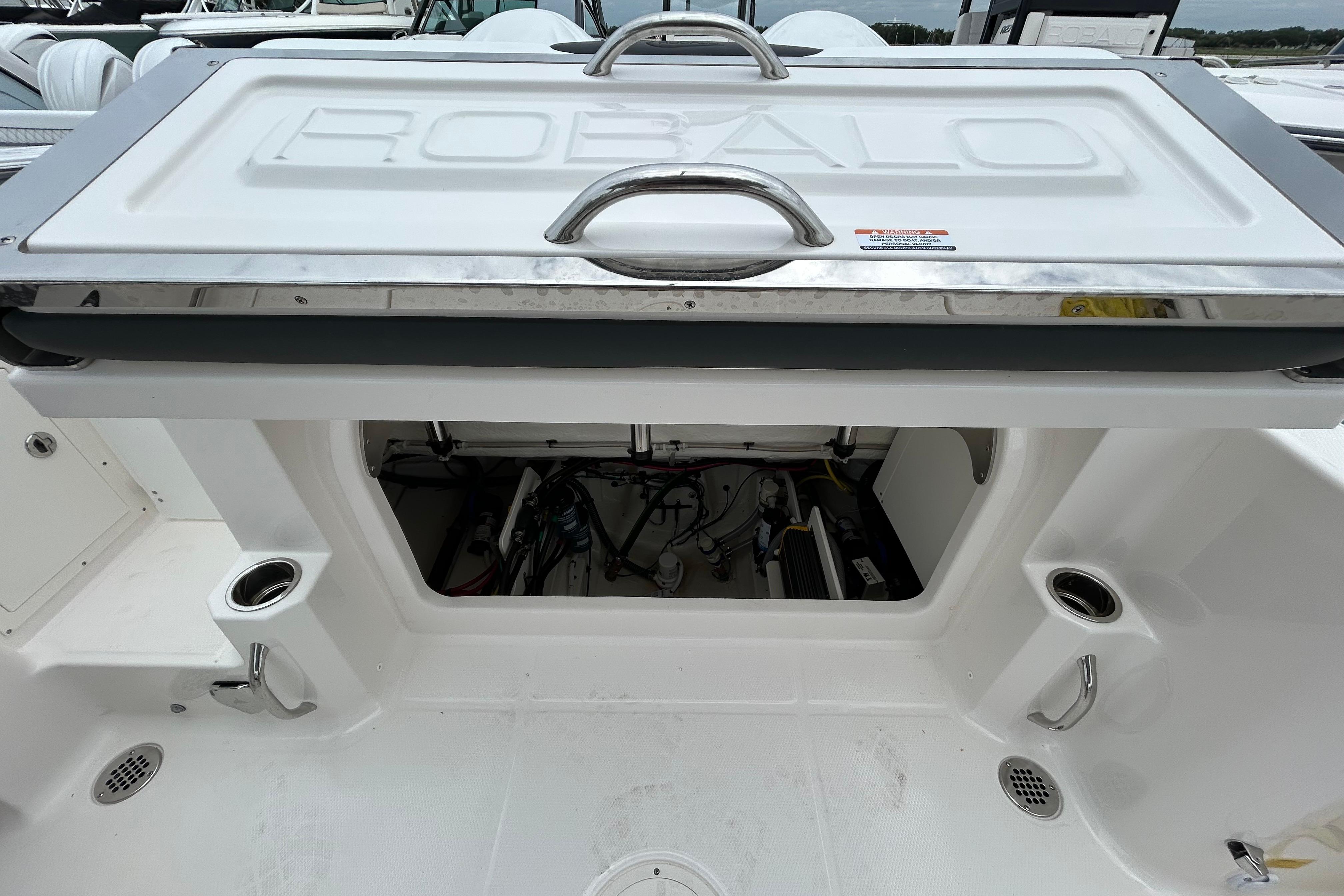 2026 Robalo R277 Dual Console boat storage compartment with open hatch and visible interior.