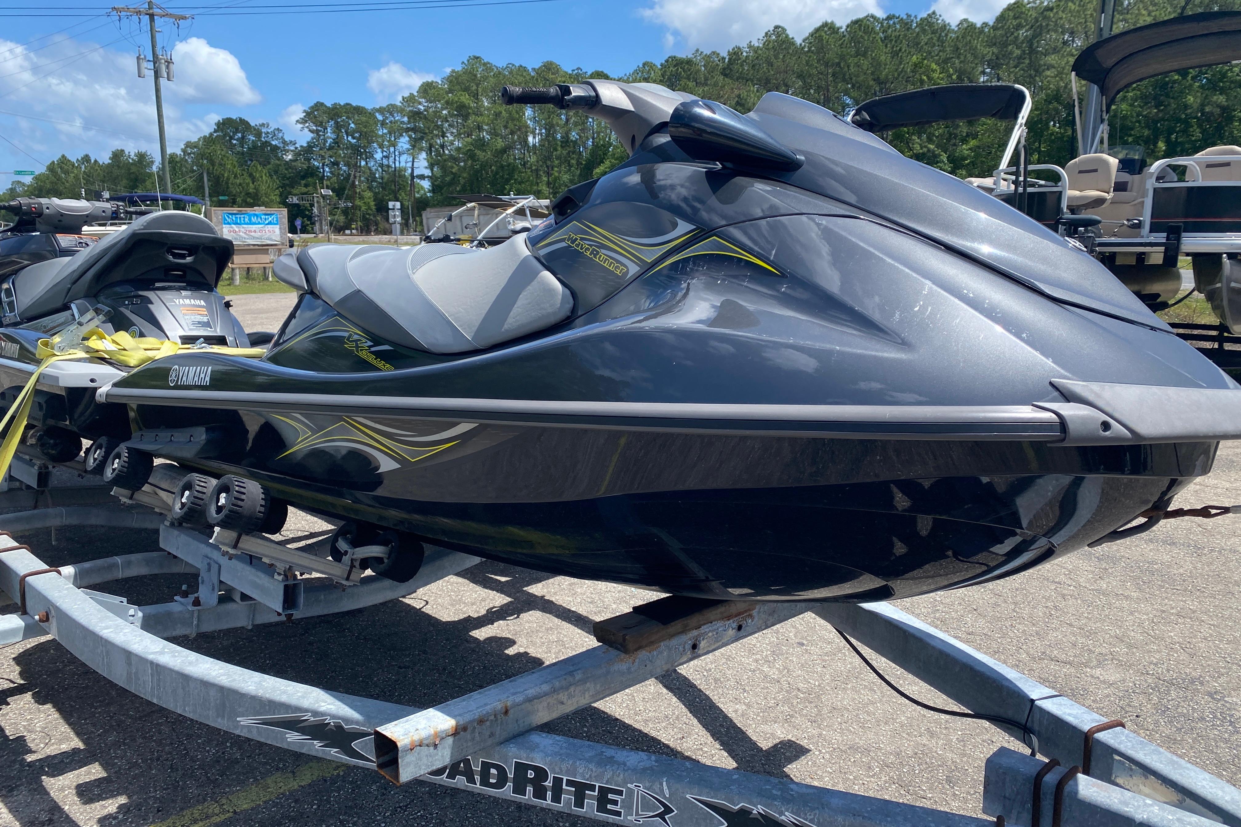 2014 Yamaha WaveRunner VX Deluxe on trailer, parked outdoors under clear sky.