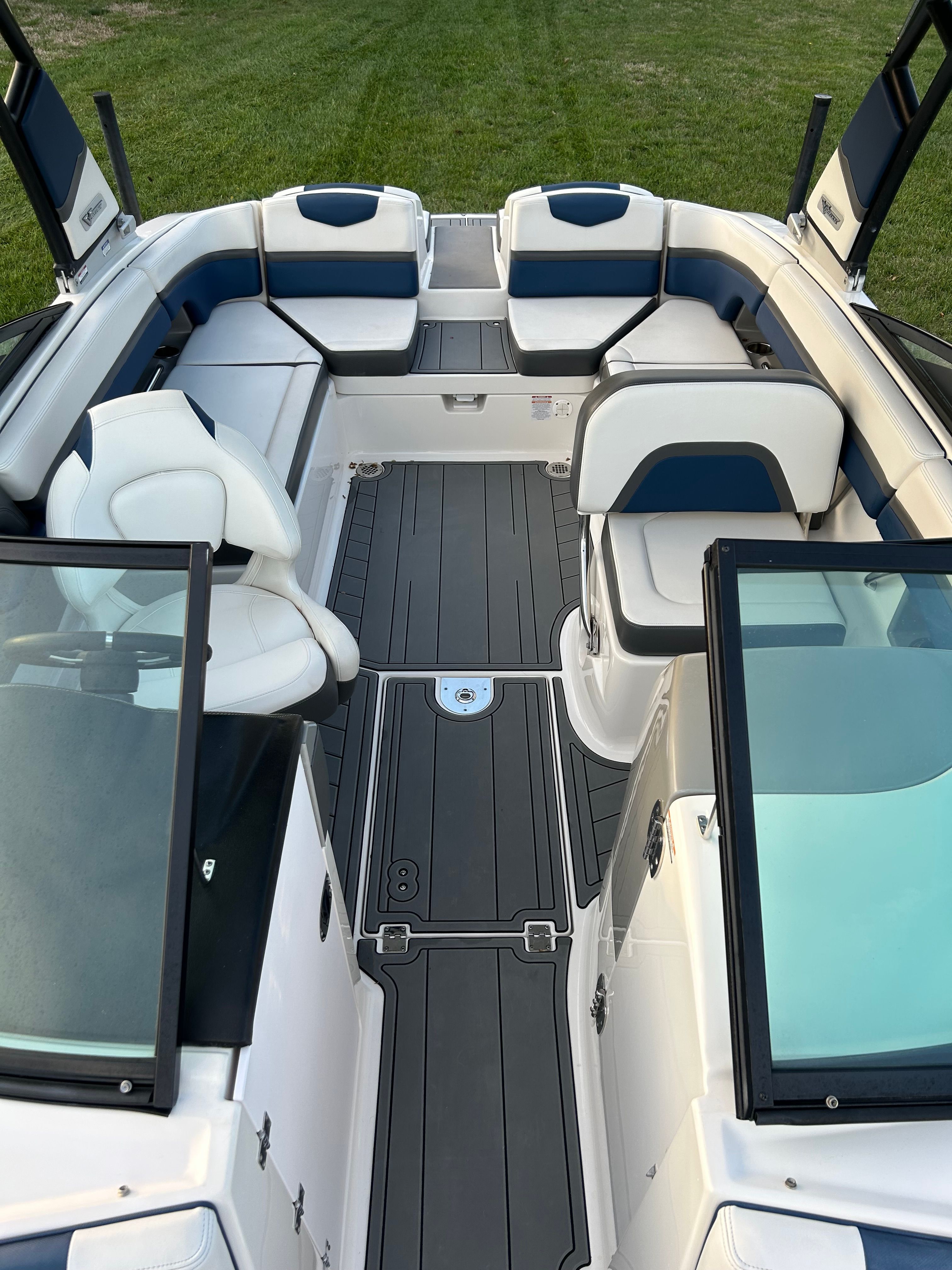 Interior of a 2015 Chaparral Vortex 243 VRX boat with blue and white seating.