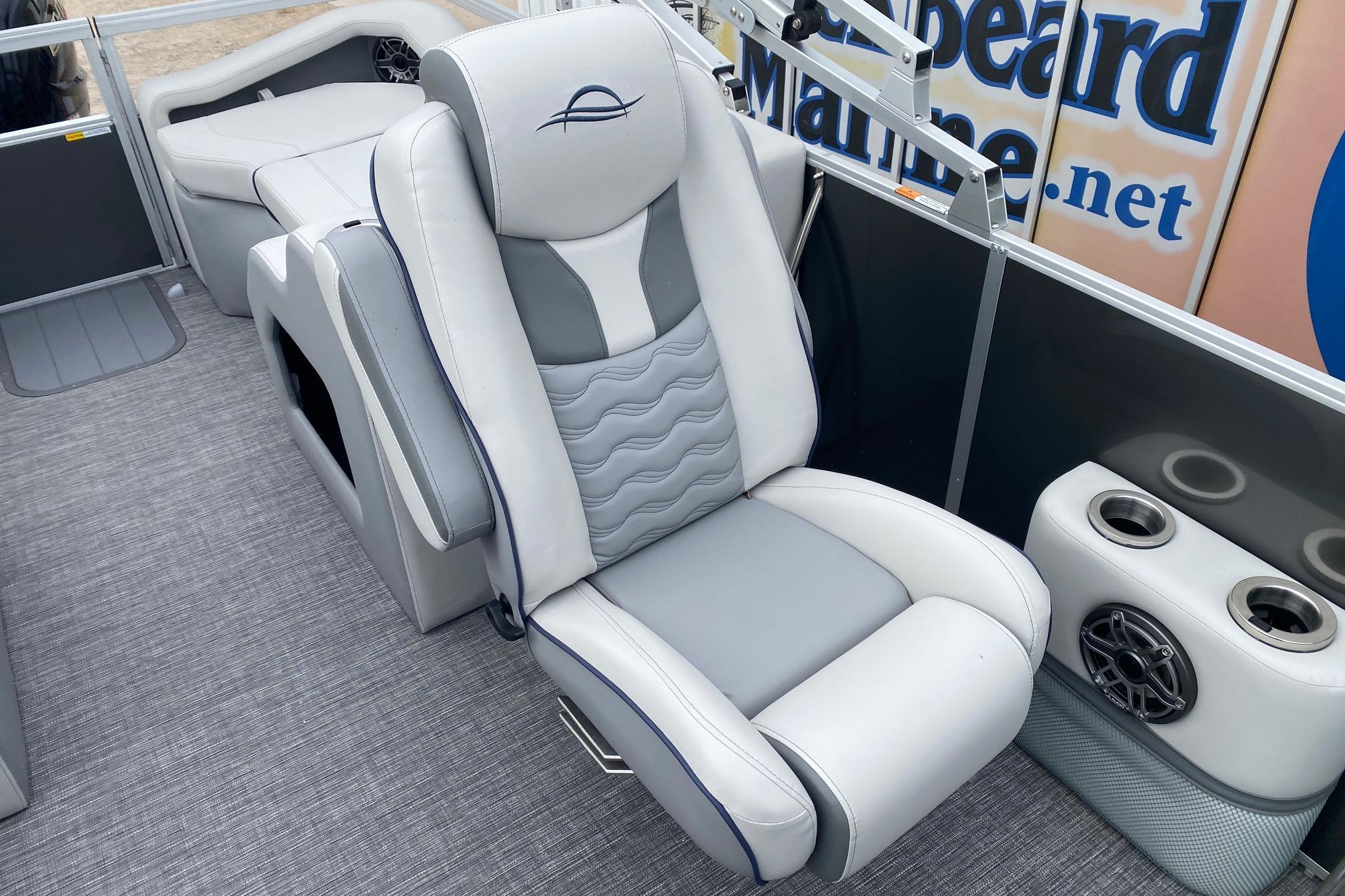 Luxurious seating on 2026 SunCatcher Diamond Elite 324 SS pontoon boat, featuring cup holders and speaker.