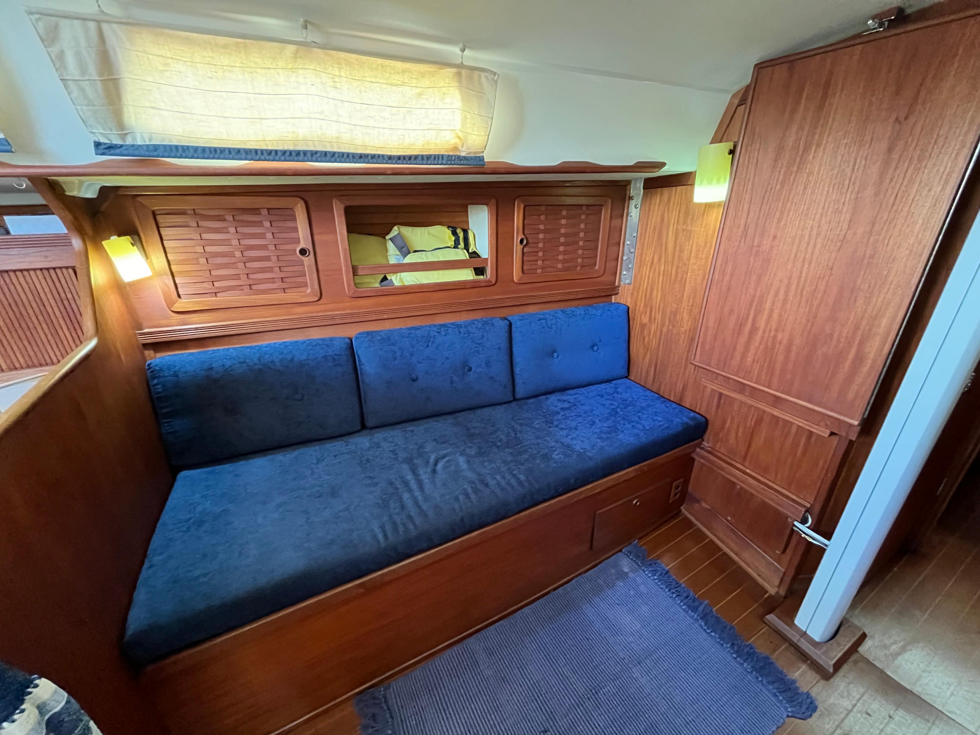 Interior of a 1988 Sabre 34 MK II yacht with blue upholstery.