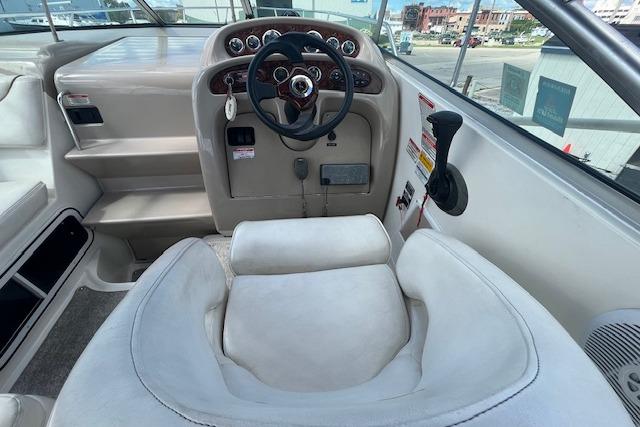 2003 Sea Ray 260 Sundancer helm with steering wheel and control panel.