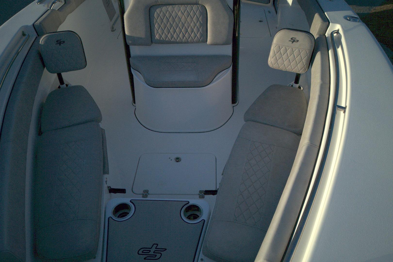2021 Sea Pro 259 Center Console boat interior with cushioned seating and cup holders.