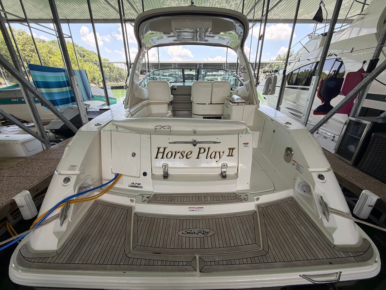 Rear view of a 2011 Sea Ray Sundancer 370 in a covered dock.
