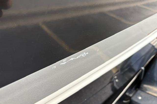 Close-up of 2017 Searay SPX210 boat surface with minor paint damage.