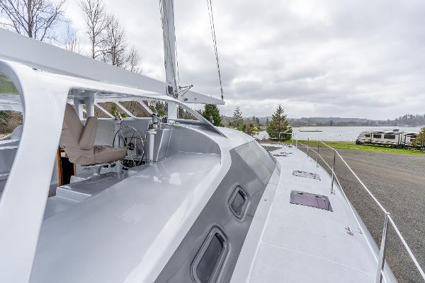 Modern 2025 Shuttleworth 52 AeroRig yacht docked by a scenic lakeside.