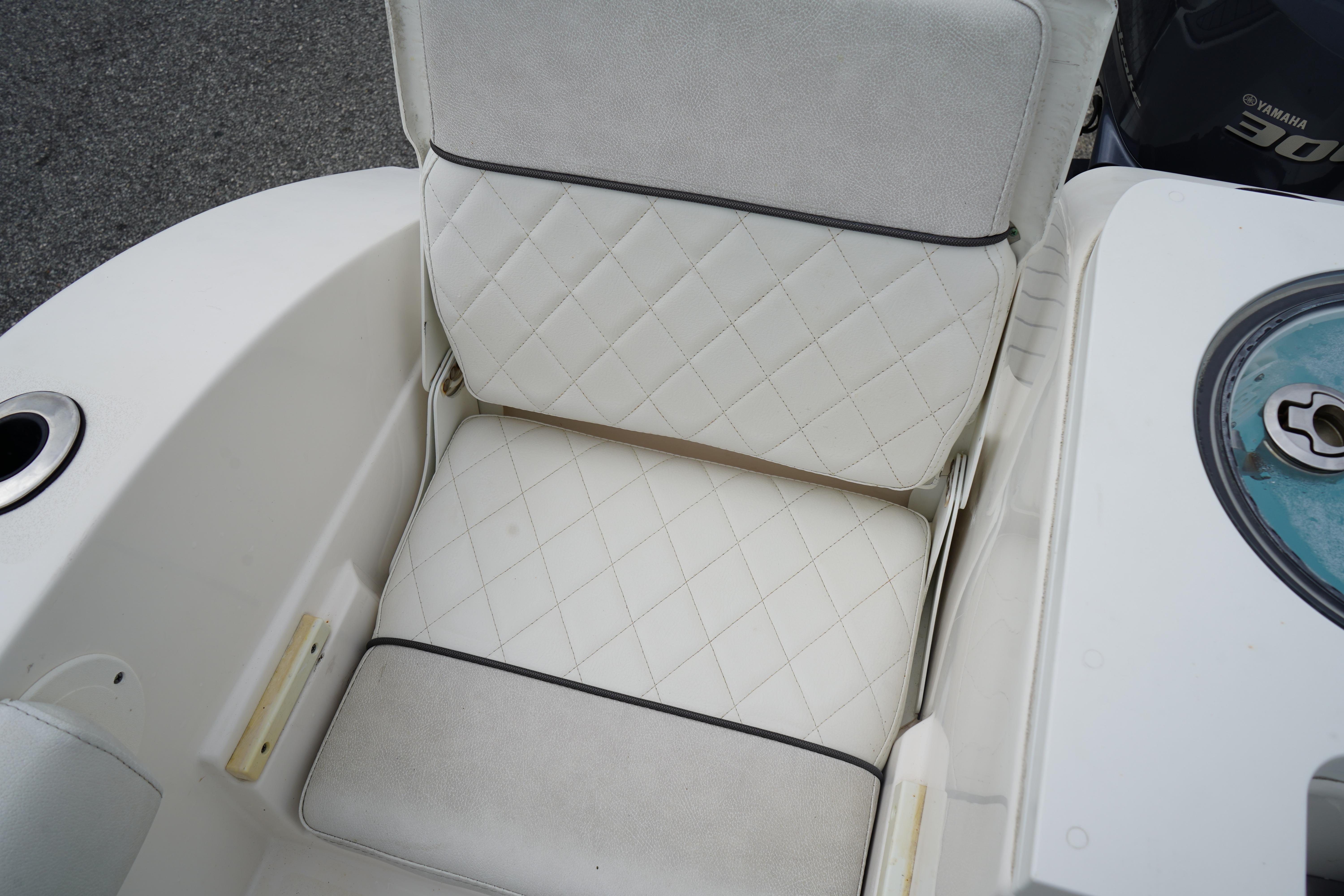 White cushioned seat on 2020 Sea Fox 328 Commander boat, featuring diamond stitching.