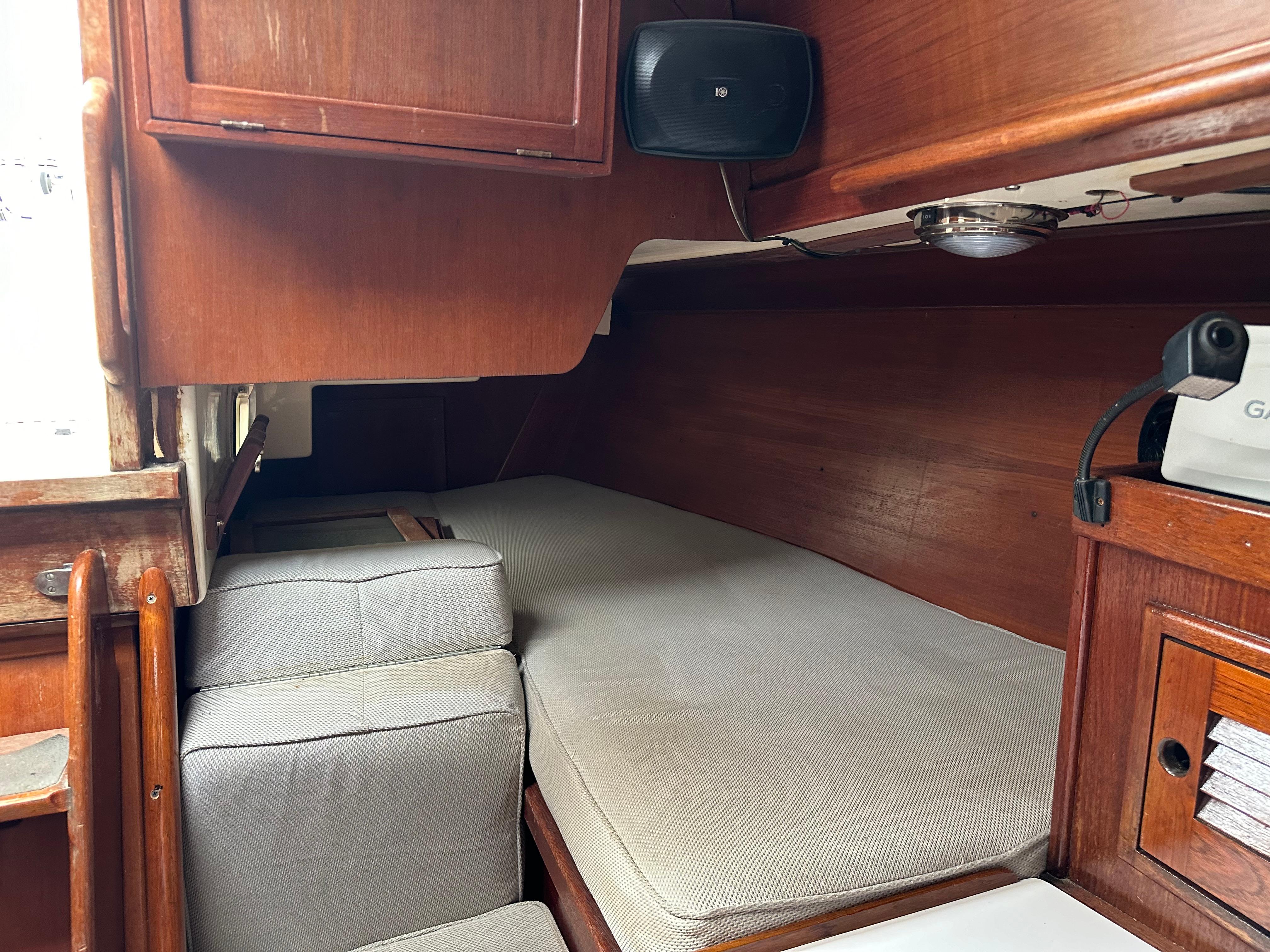 Interior cabin of 1981 Tartan 37 sloop with wooden finish and cushioned seating.