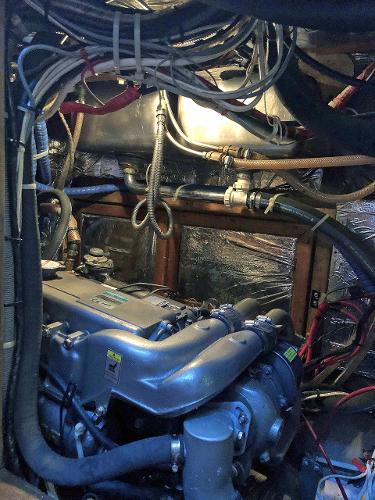 Engine room of the 1988 Little Harbor 53 with complex wiring and pipes.