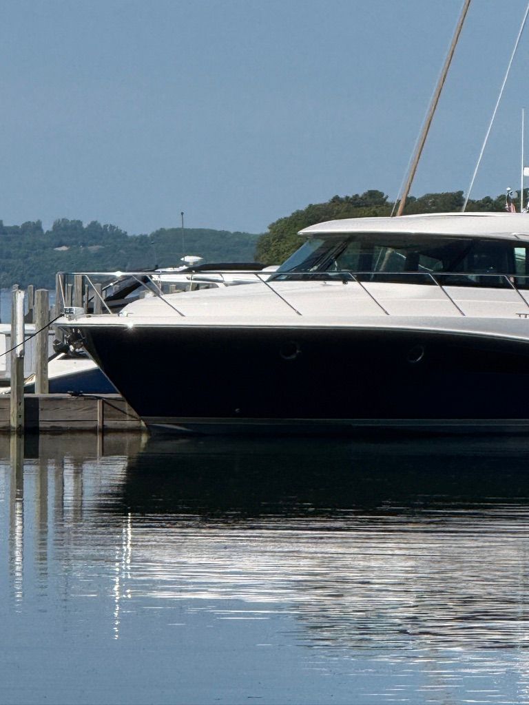 A 2017 Tiara Yachts C44 Coupe docked in calm waters.