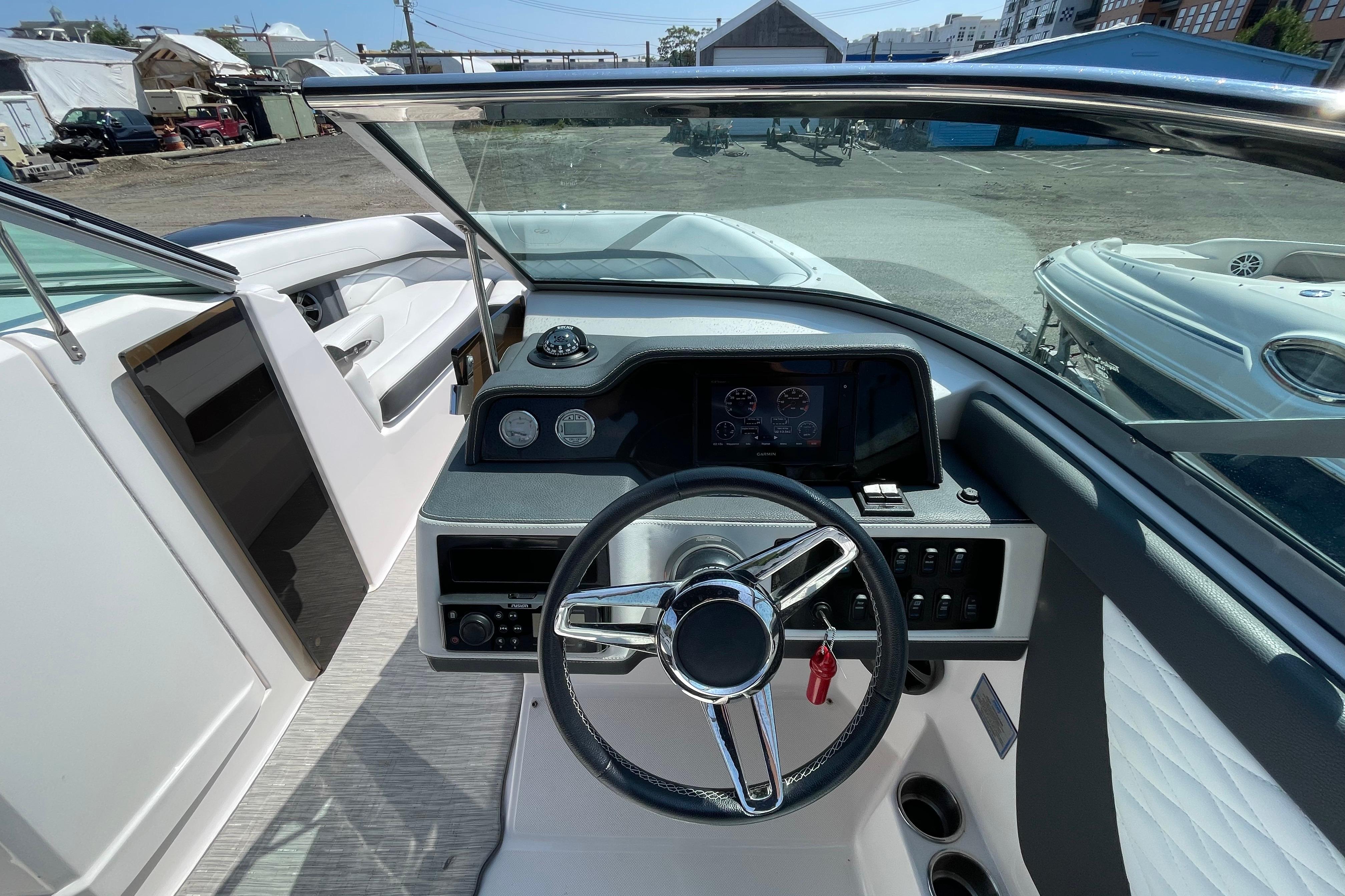 2018 Regal 26 OBX boat dashboard with steering wheel and control panel.