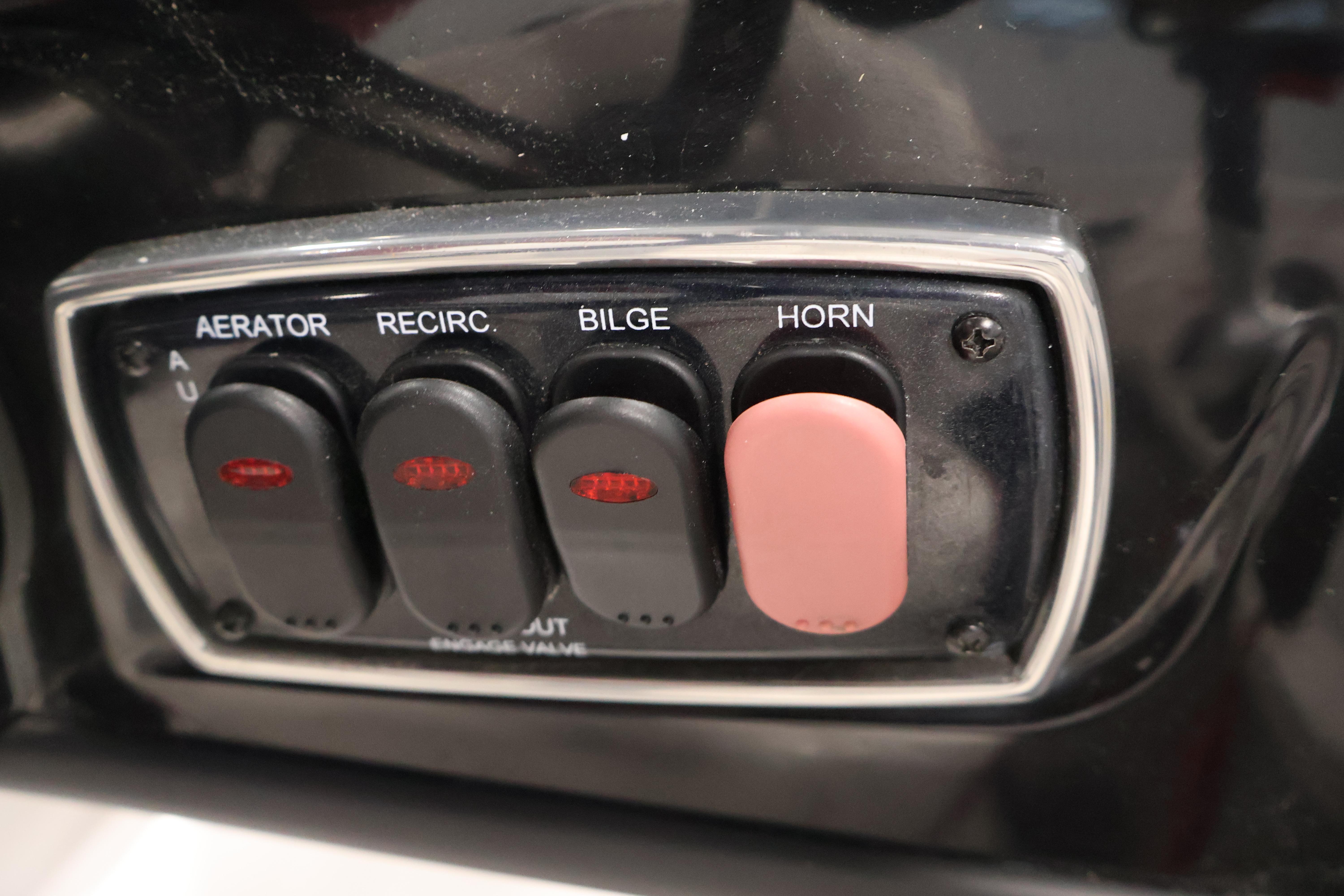 Control panel of a 2019 Nitro Z19 Sport boat with switches for aerator, recirculation, bilge, and horn.