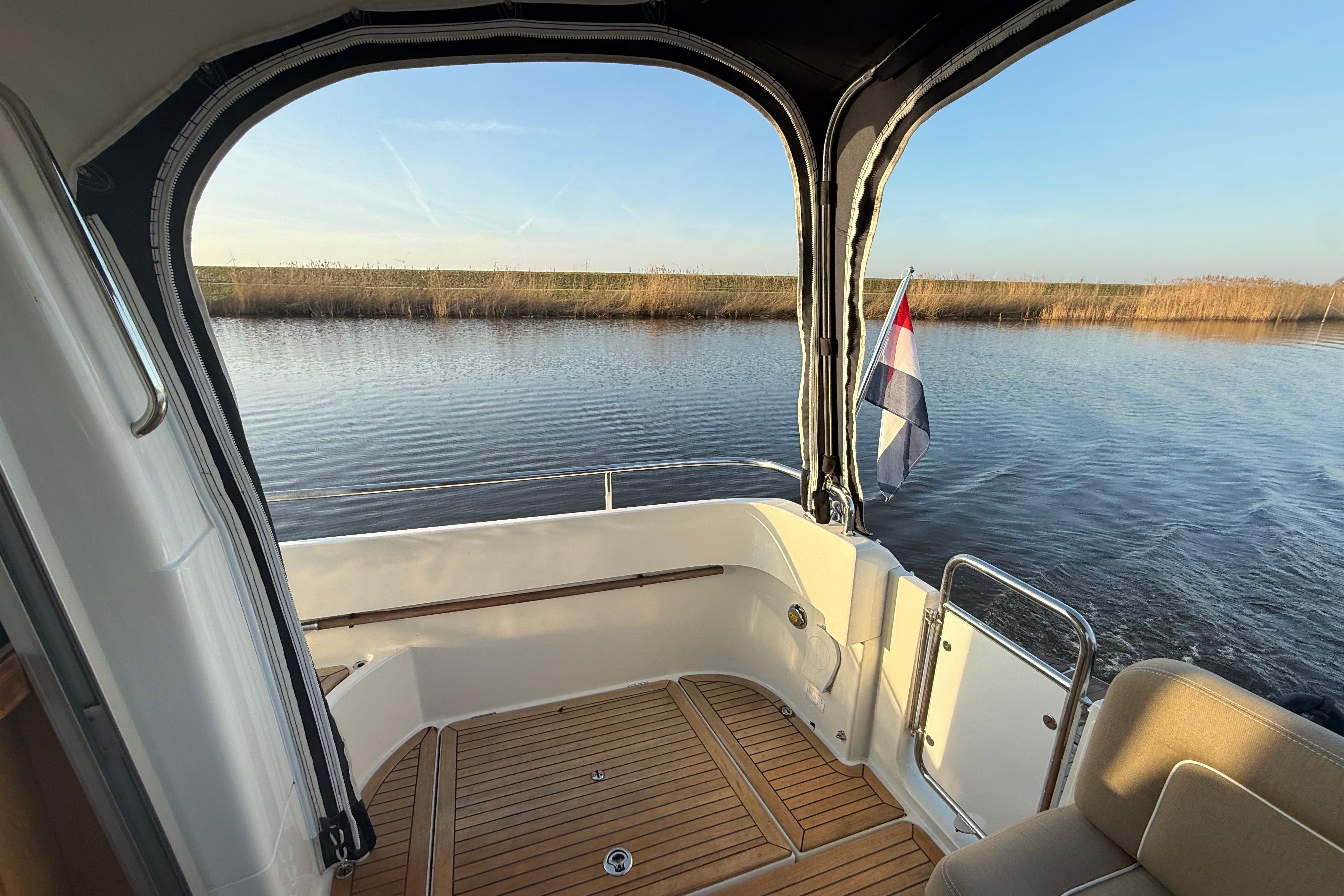 Nimbus 335 Coupe 2011 boat interior with scenic water view and flag.