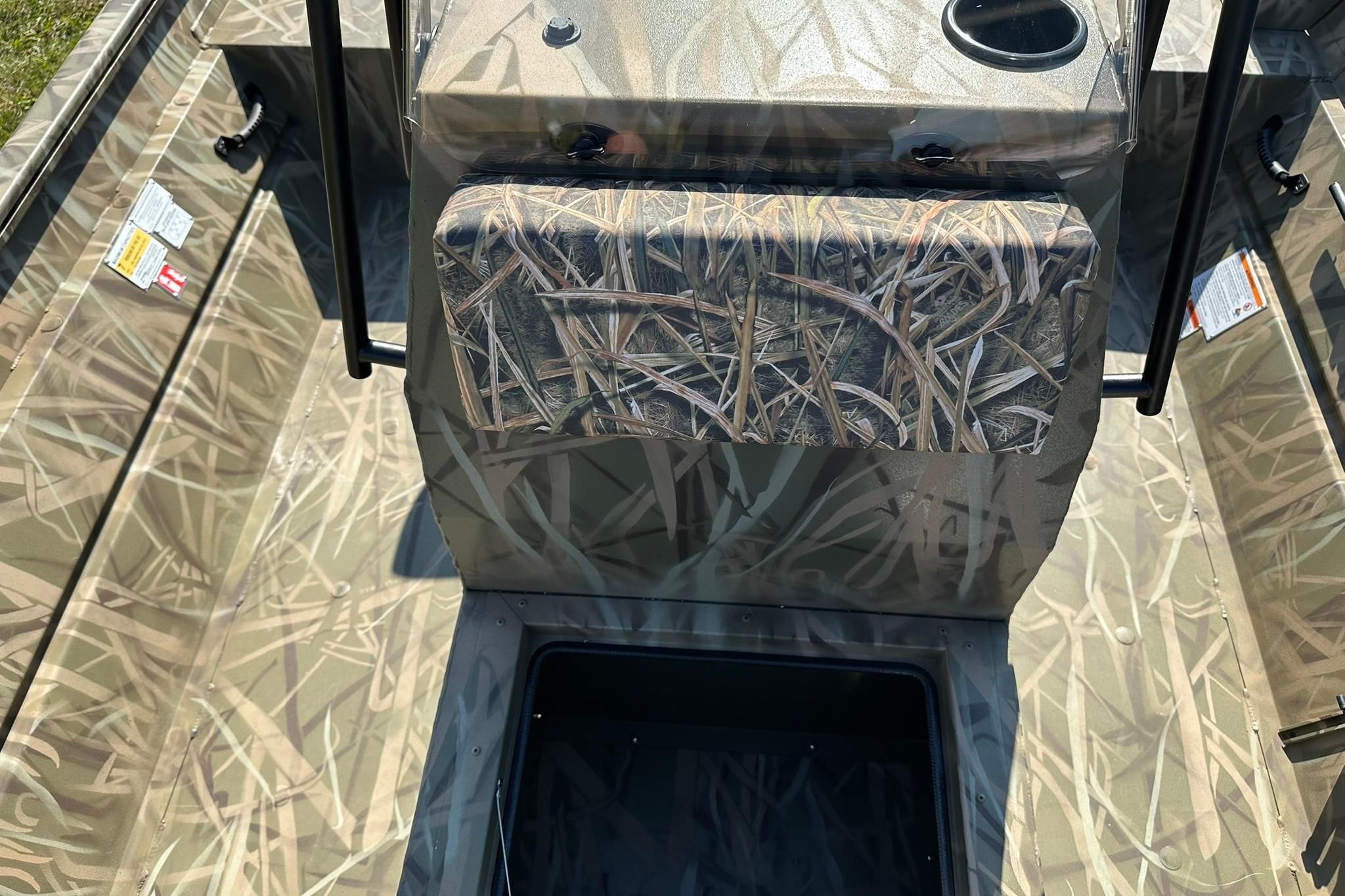 2026 Lowe Roughneck 2070CC boat interior with camouflage design and storage compartment.