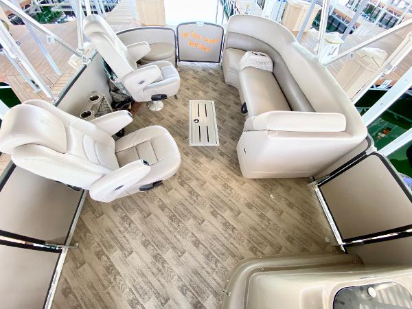 Interior of a 2011 Premier 275 Grand Majestic PTX with beige seating and wood flooring.