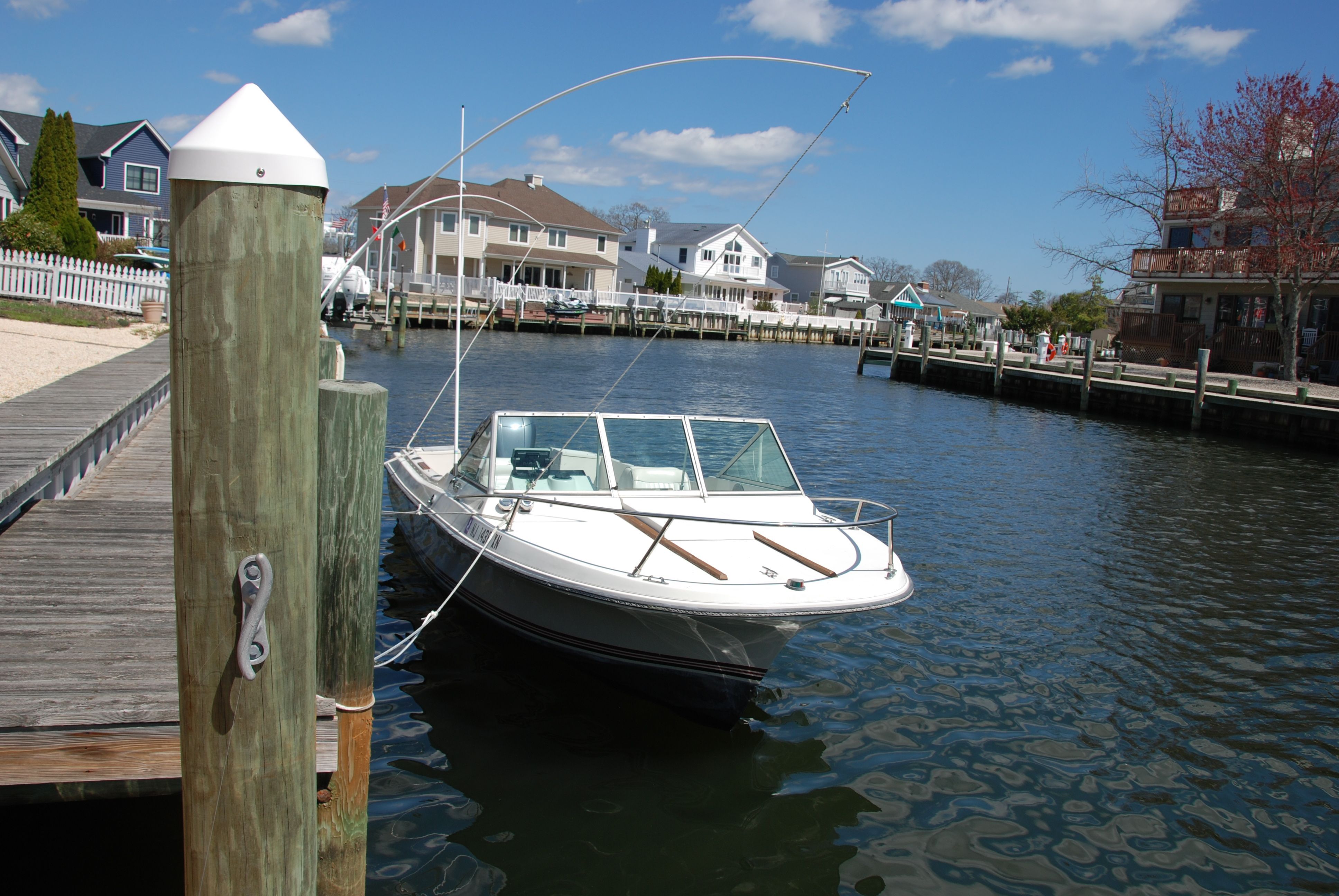 A 1987 Wellcraft V-20 Steplift docked in a calm harbor setting.