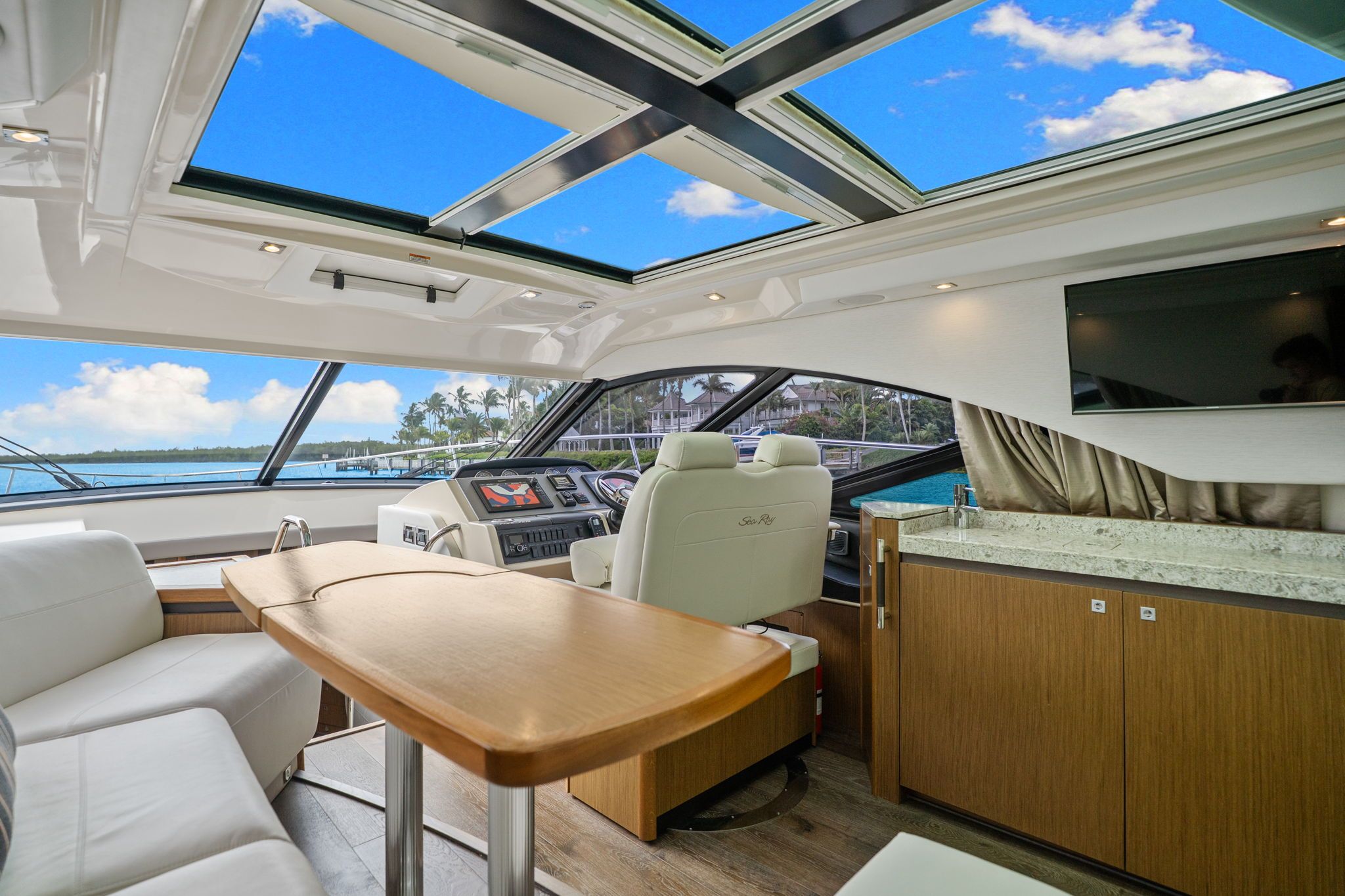 Interior of a 2017 Sea Ray Sundancer 510 with luxurious seating and panoramic windows.
