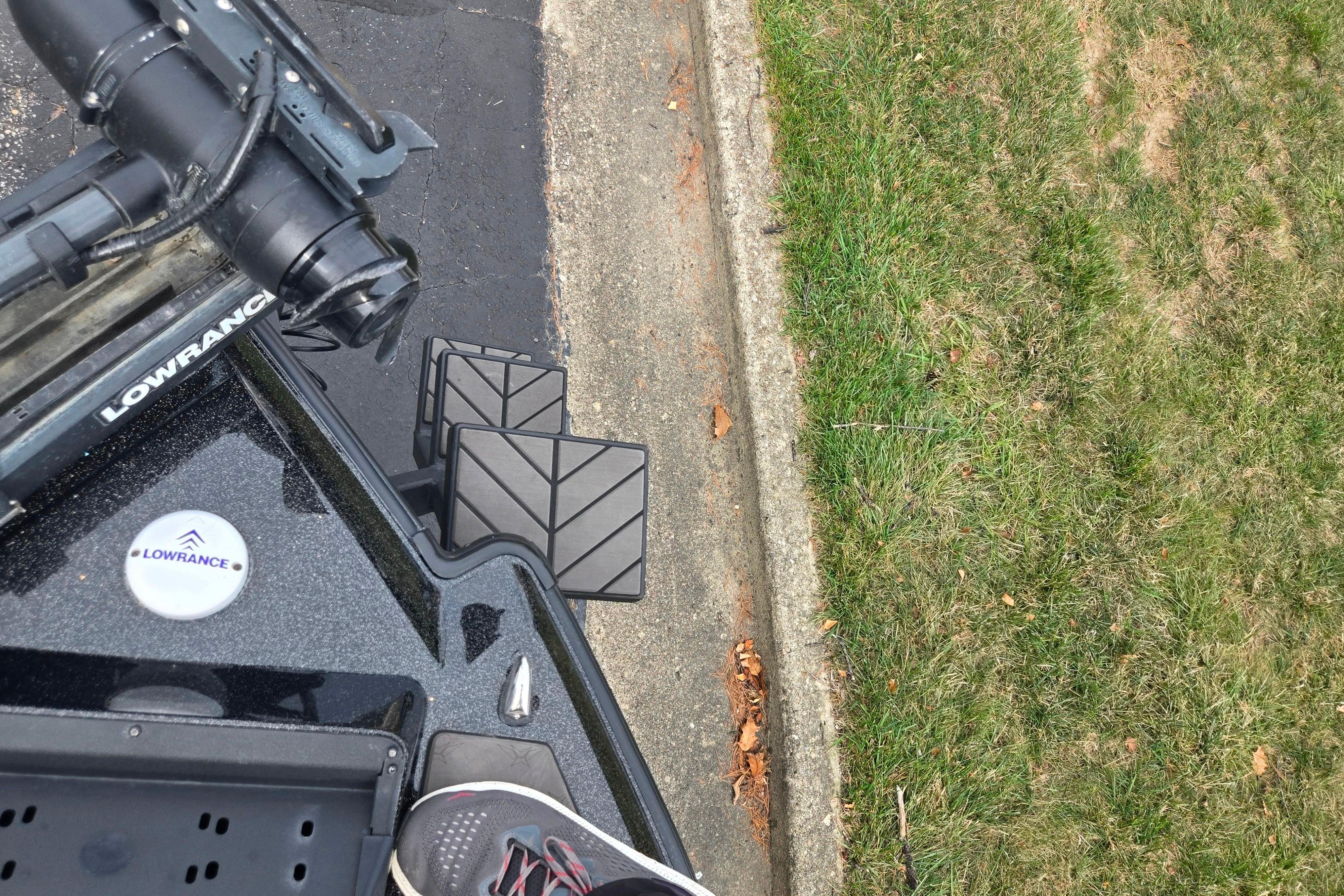 2022 Vexus VX20 boat with Lowrance equipment, parked near grass and pavement.