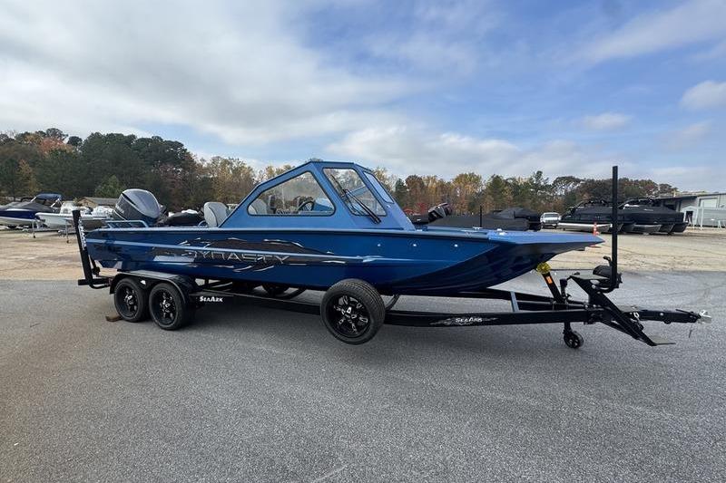 2026 SeaArk Dynasty 2.0 boat in blue on a trailer, parked outdoors.