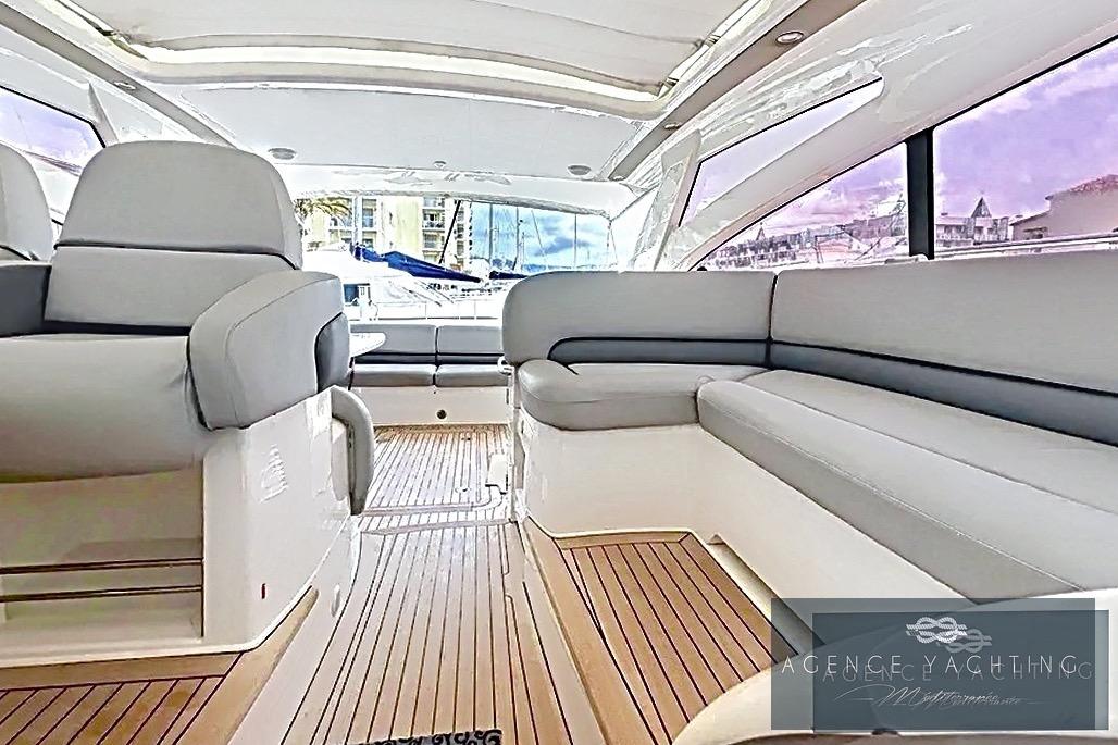 Luxurious interior of 2004 Princess V58 yacht with sleek seating and wooden flooring.