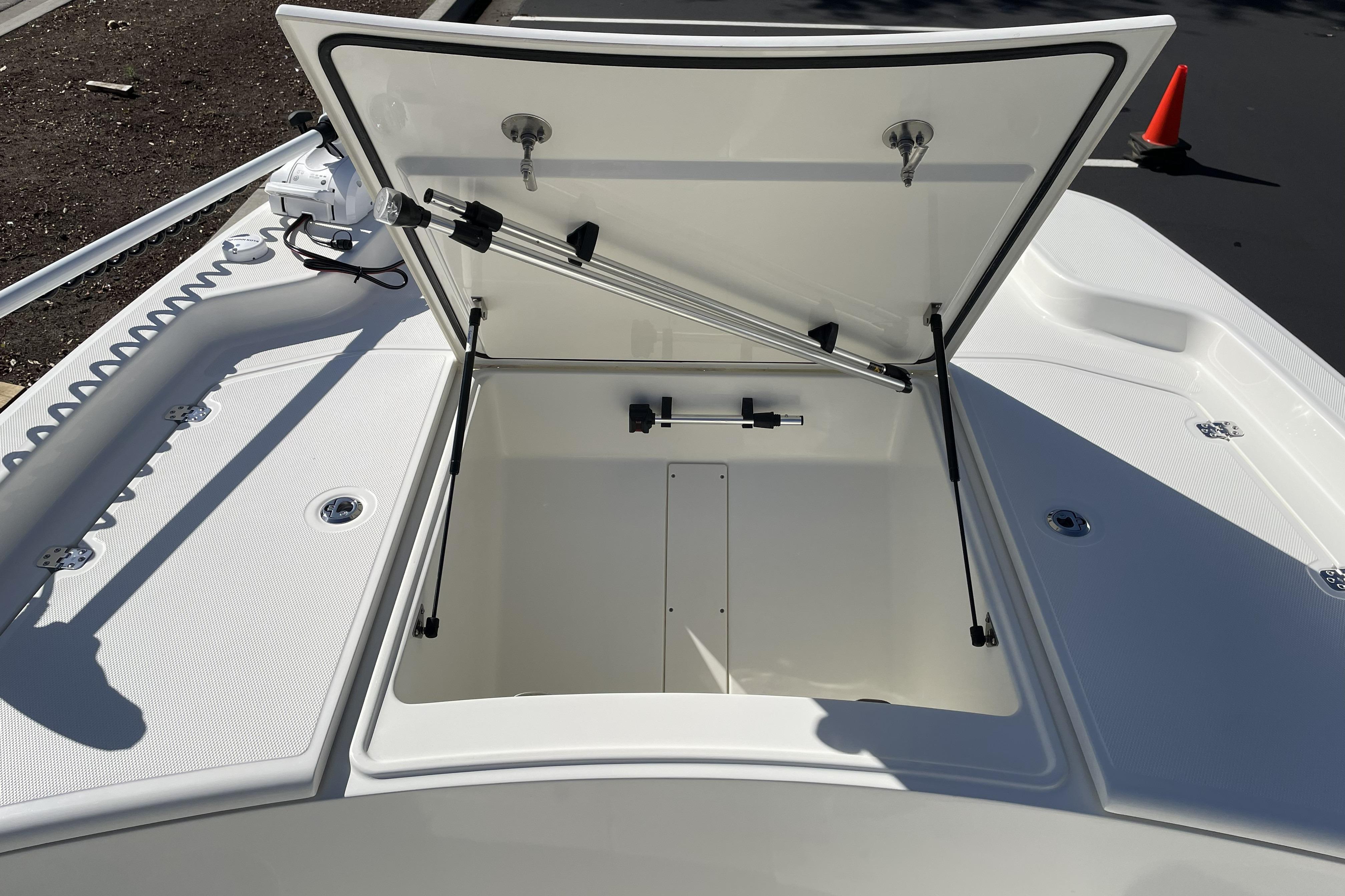 Open storage compartment on 2026 Mako Pro Skiff 19 CC boat deck.