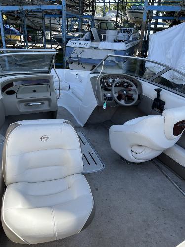 2005 Crownline 180 BR boat interior with white seating and dashboard.