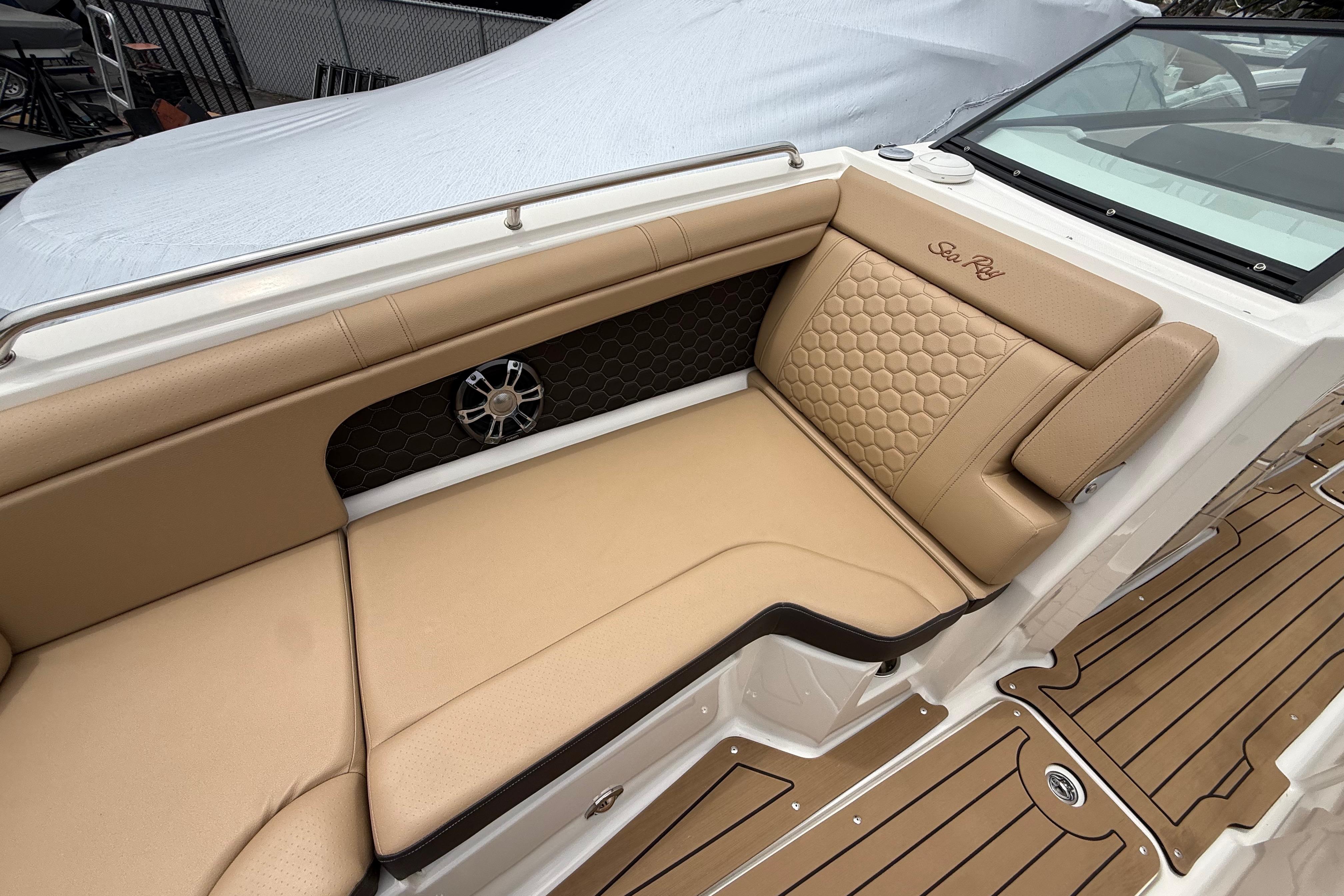 2022 Sea Ray SDX 290 Outboard boat interior with tan seating and wood-style flooring.