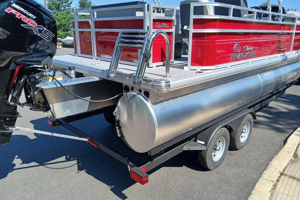 2026 Sun Tracker SportFish 20 DLX pontoon boat with Mercury Pro XS engine on trailer.