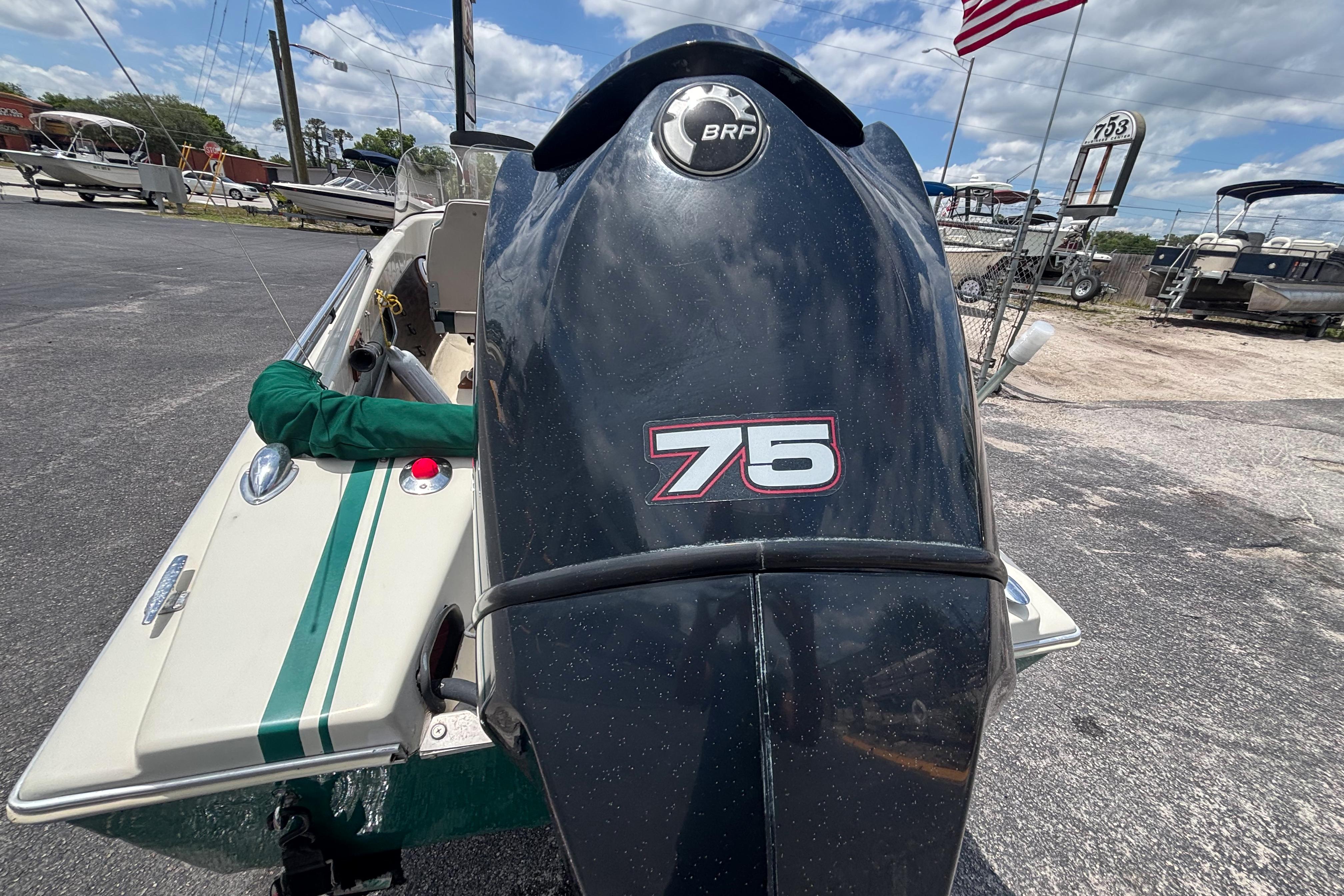 1966 Mohawk 15 boat with BRP 75 outboard motor, parked outdoors.