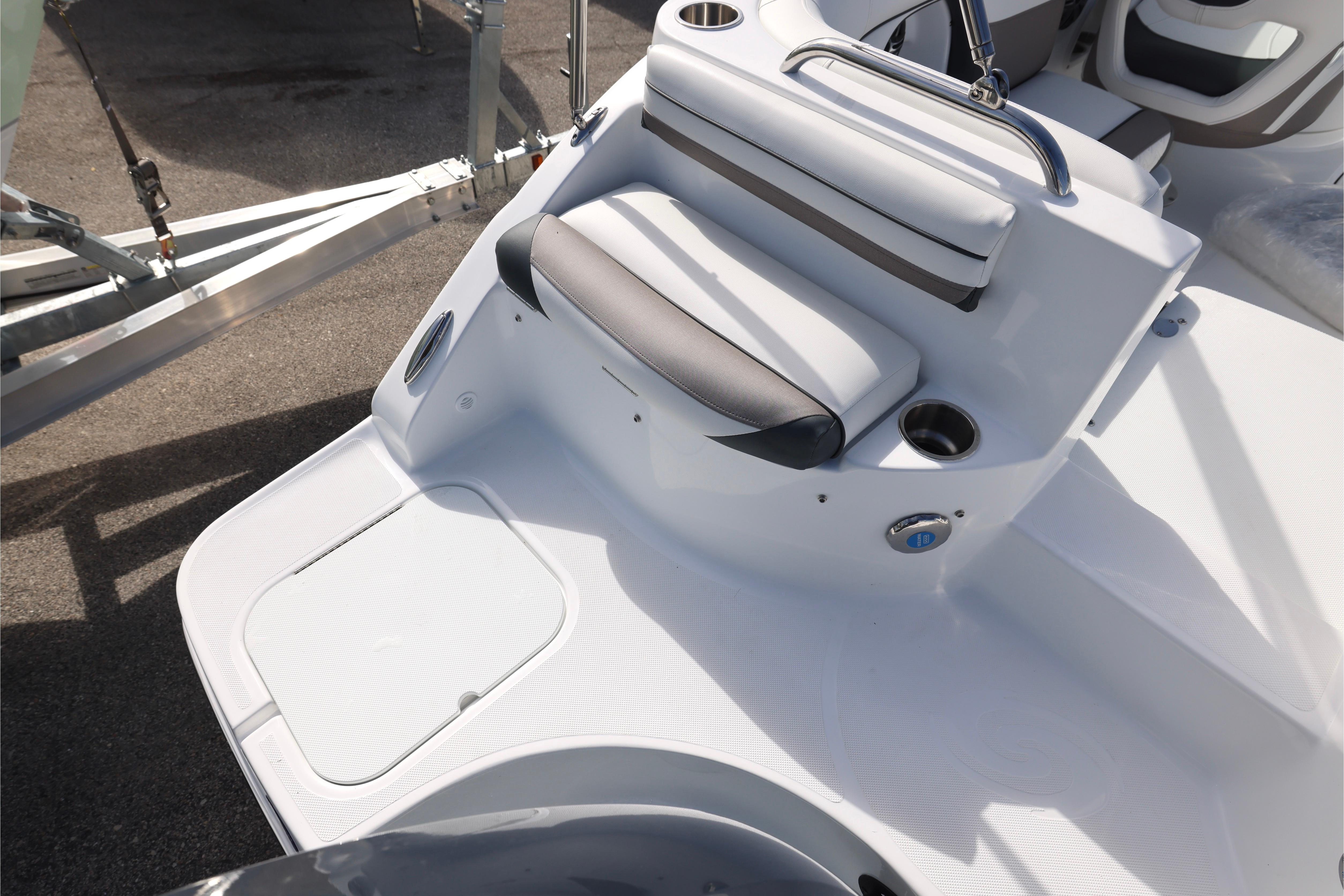 2026 Hurricane SunDeck 2486 OB boat interior with seating and cup holders.