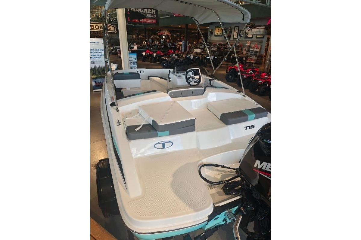 2026 Tahoe T16 boat with seating and canopy, displayed indoors.