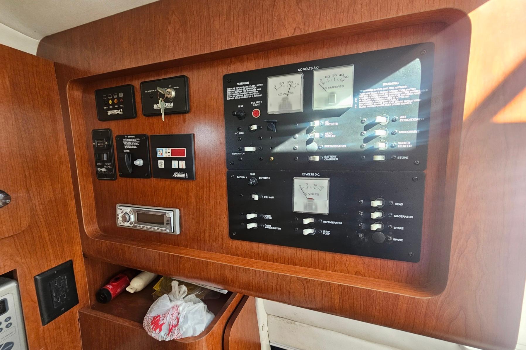 Control panel of a 2006 Pro-Line 32 Express boat with various switches and gauges.