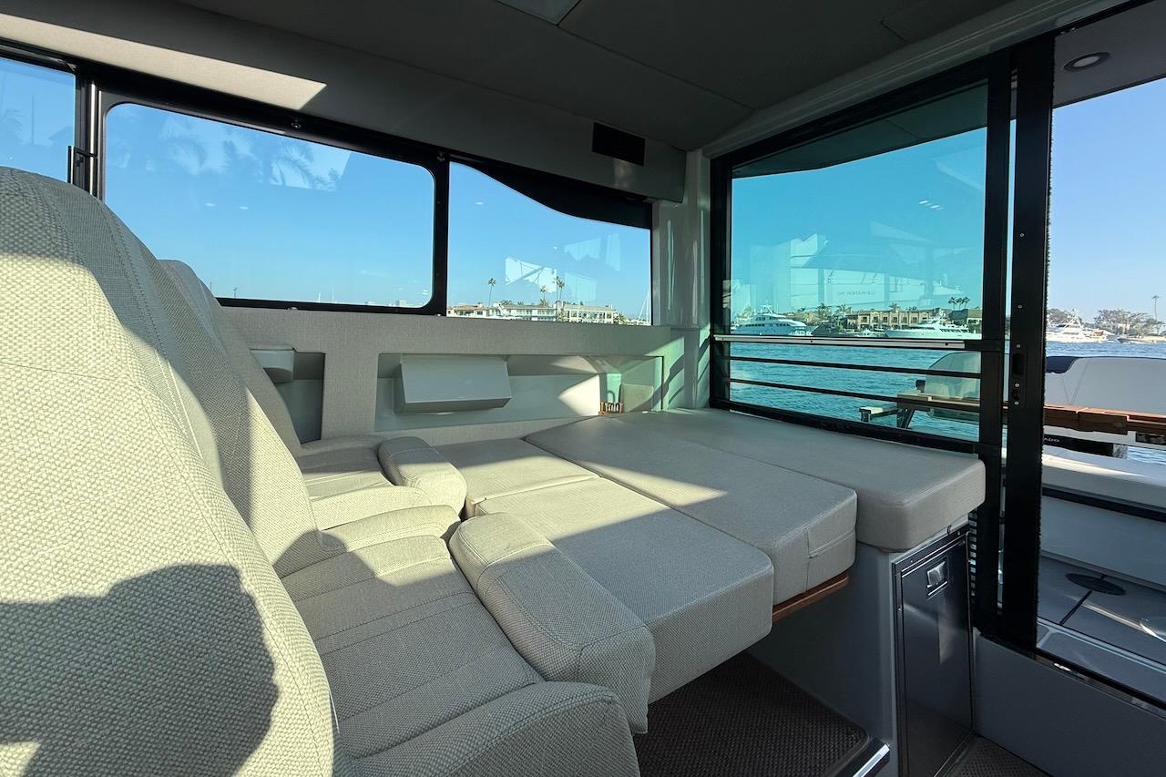 Interior of 2024 Saxdor 320 GTC boat with comfortable seating and waterfront view.