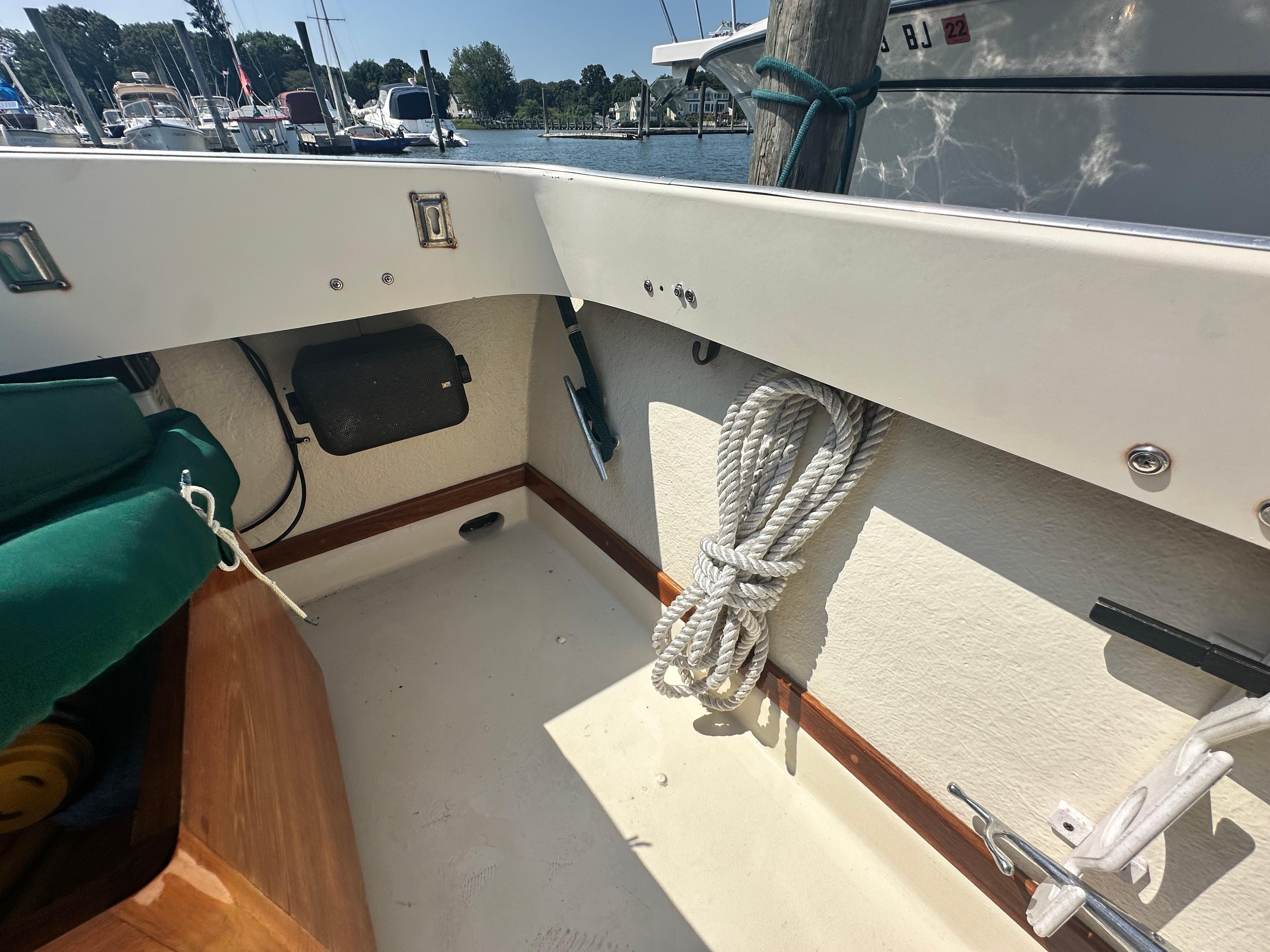 Interior of a 1979 Fortier 26 boat with rope and dock view.