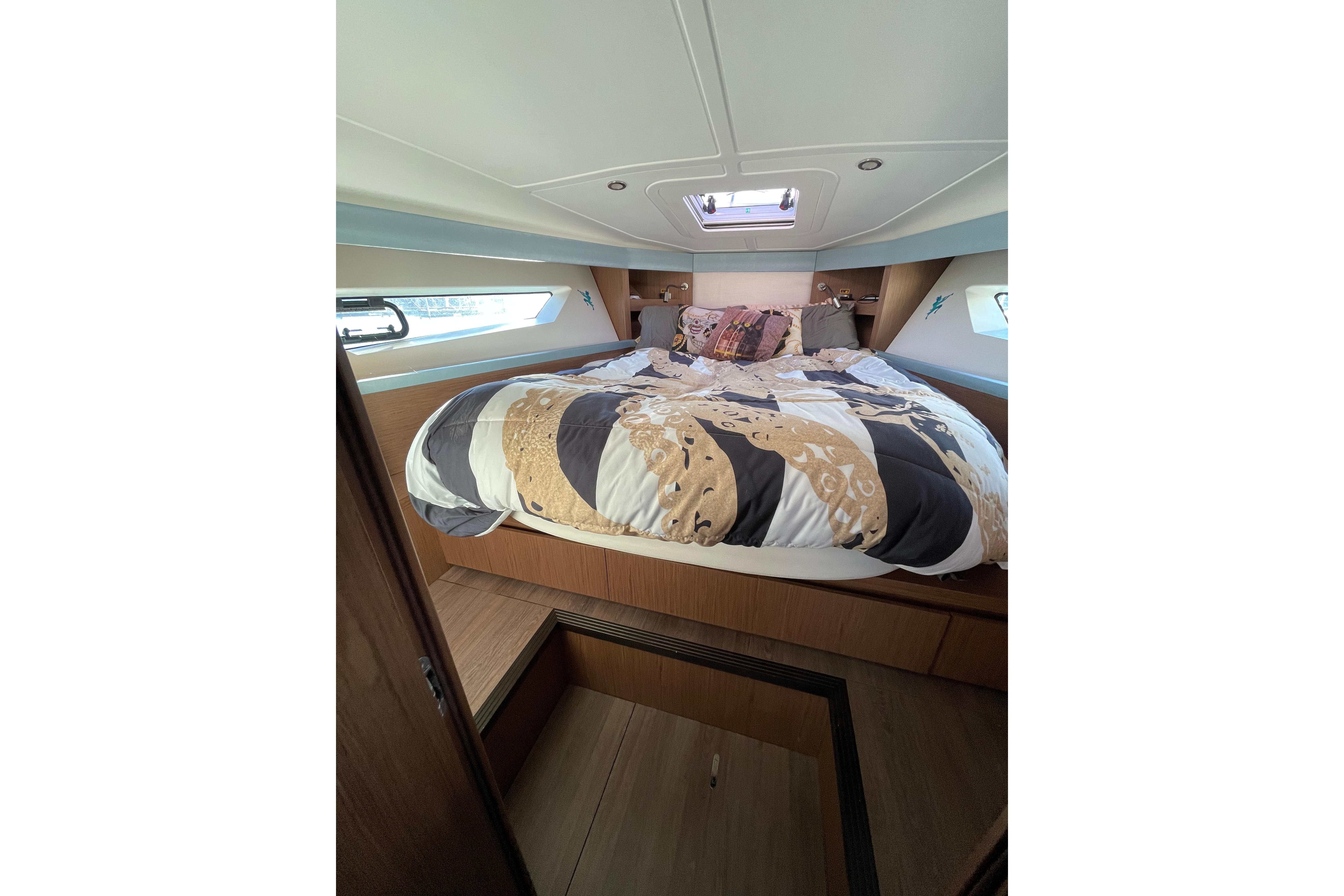 Luxurious cabin interior of 2018 Benetau Gran Turismo 40 yacht with cozy bedding.