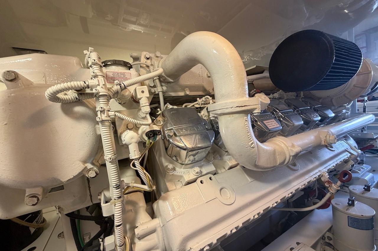 Engine room of a 2012 Viking 50 Convertible yacht, showcasing detailed machinery components.
