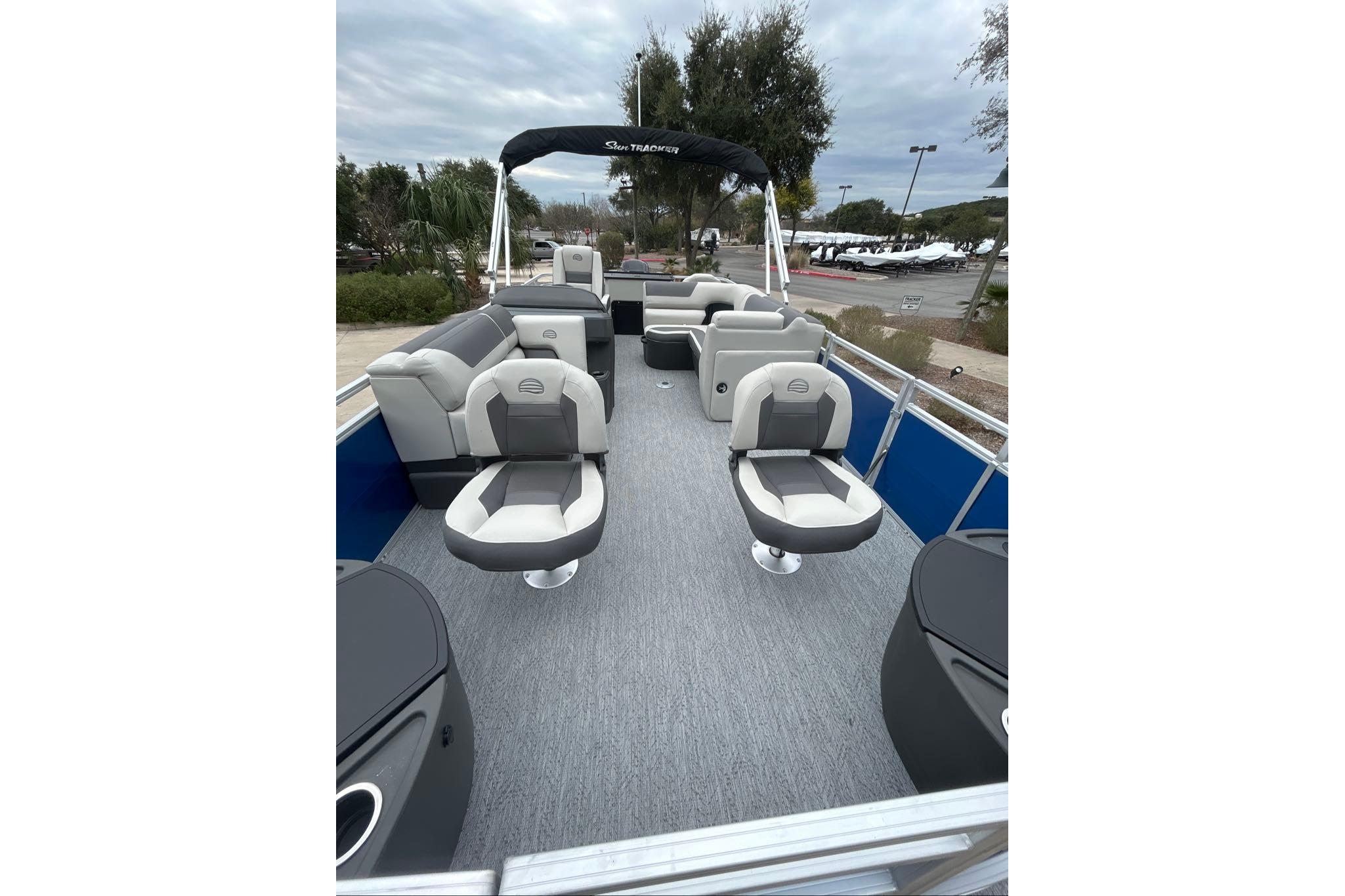 2026 Sun Tracker Fishin' Barge 20 DLX pontoon boat with spacious seating and canopy.