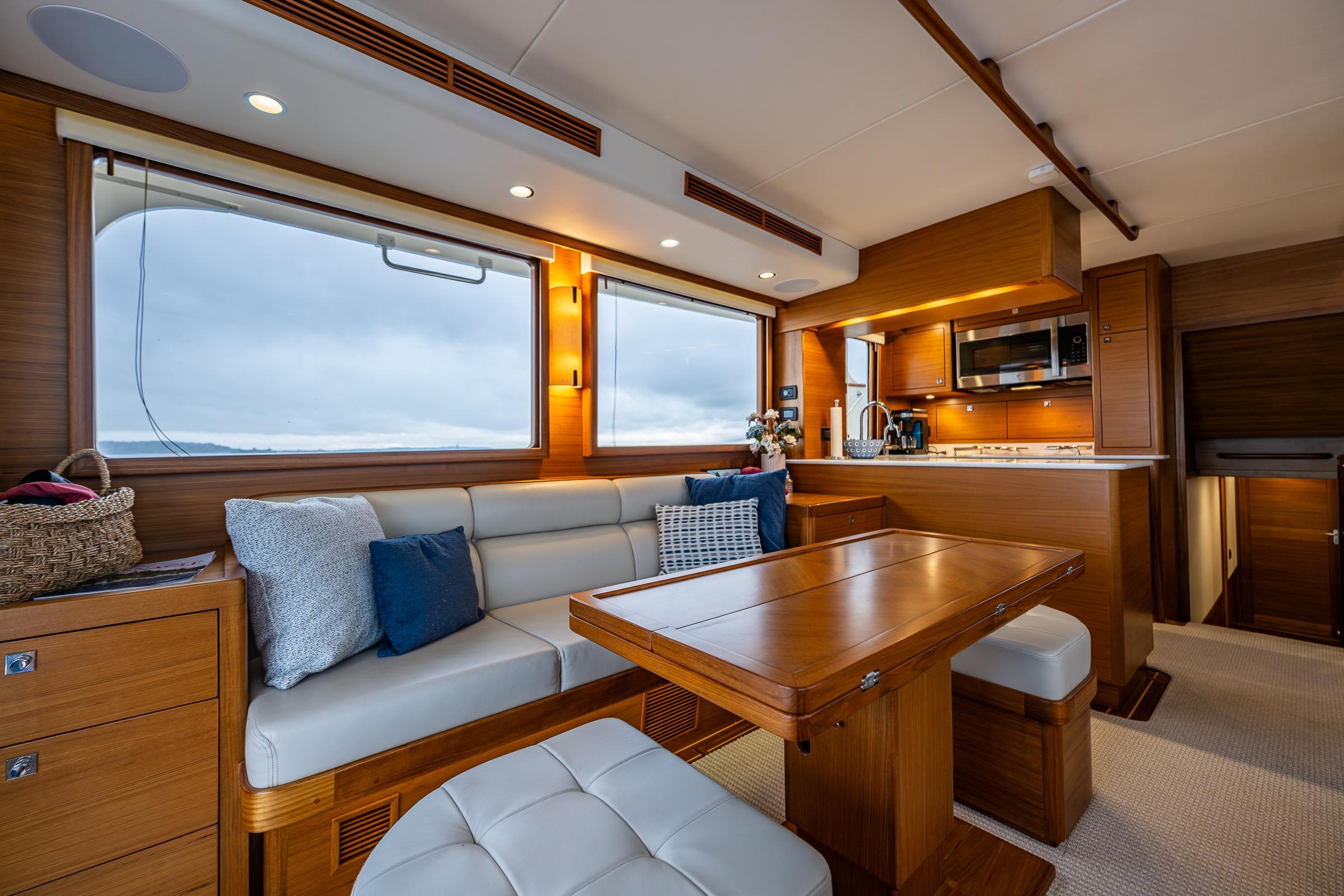 Luxurious interior of 2026 Fleming 55 Pilothouse yacht with elegant wood finishes and modern amenities.