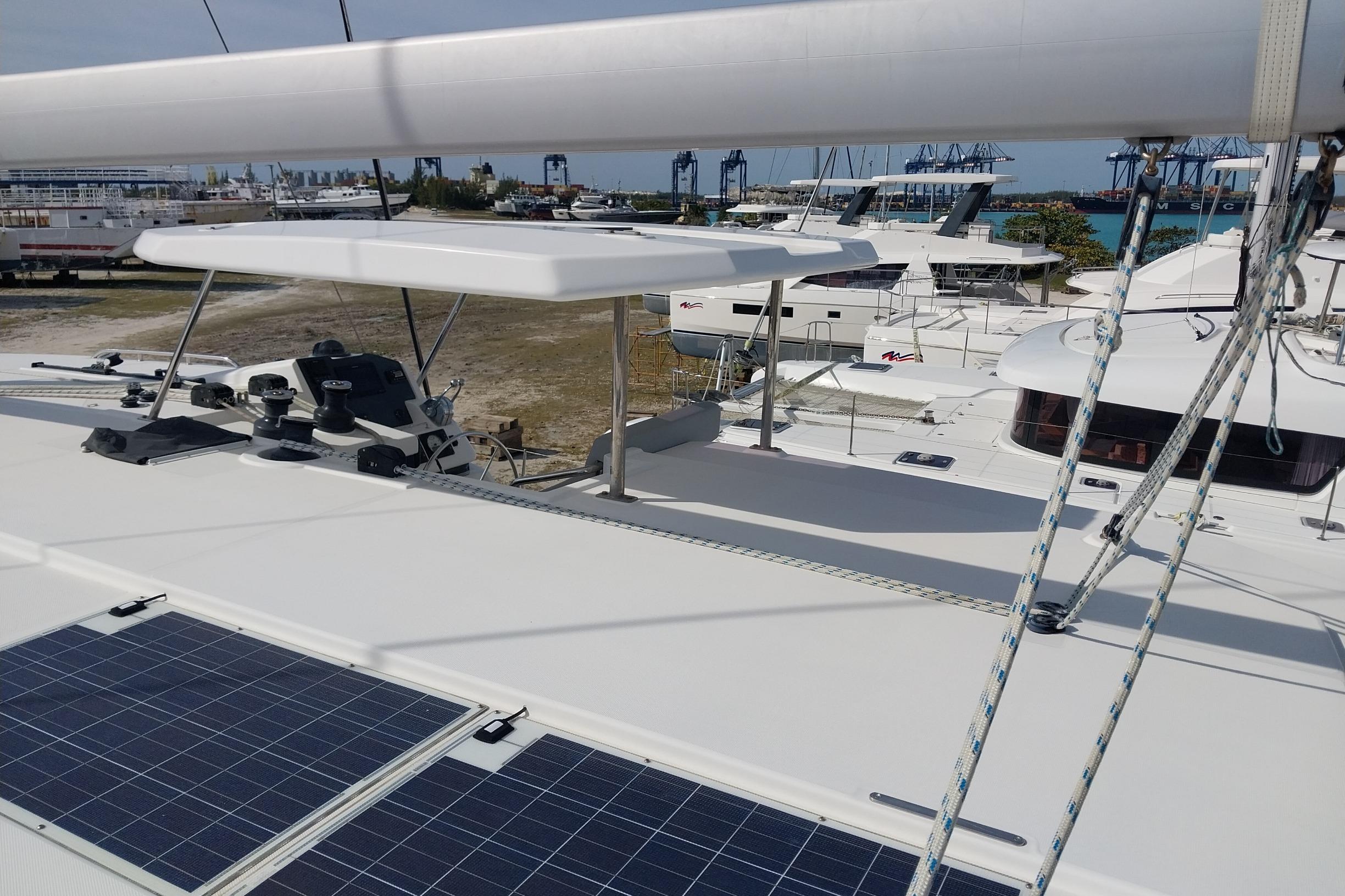 2020 Leopard 45 catamaran with solar panels and marina view.
