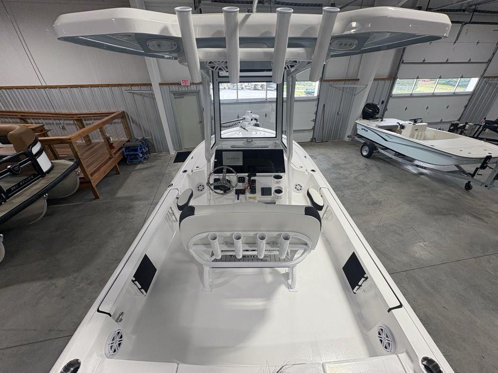 2026 Tidewater 2110 BM boat interior with steering console and seating in a showroom.
