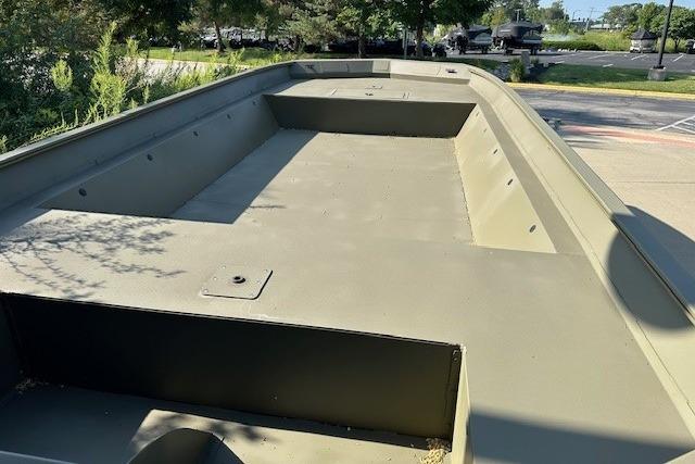 2025 Tracker GRIZZLY 2072 Utility boat, spacious deck, parked outdoors.