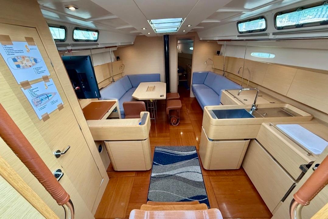 Interior of 2009 Beneteau First 50 yacht, featuring modern kitchen and seating area.