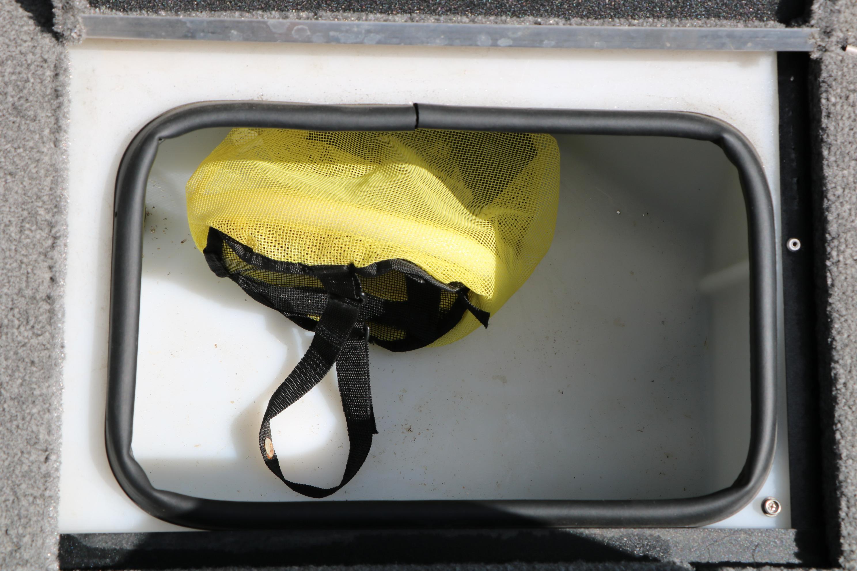 Storage compartment with yellow mesh bag in 2023 Alumacraft Competitor FSX 185 boat.