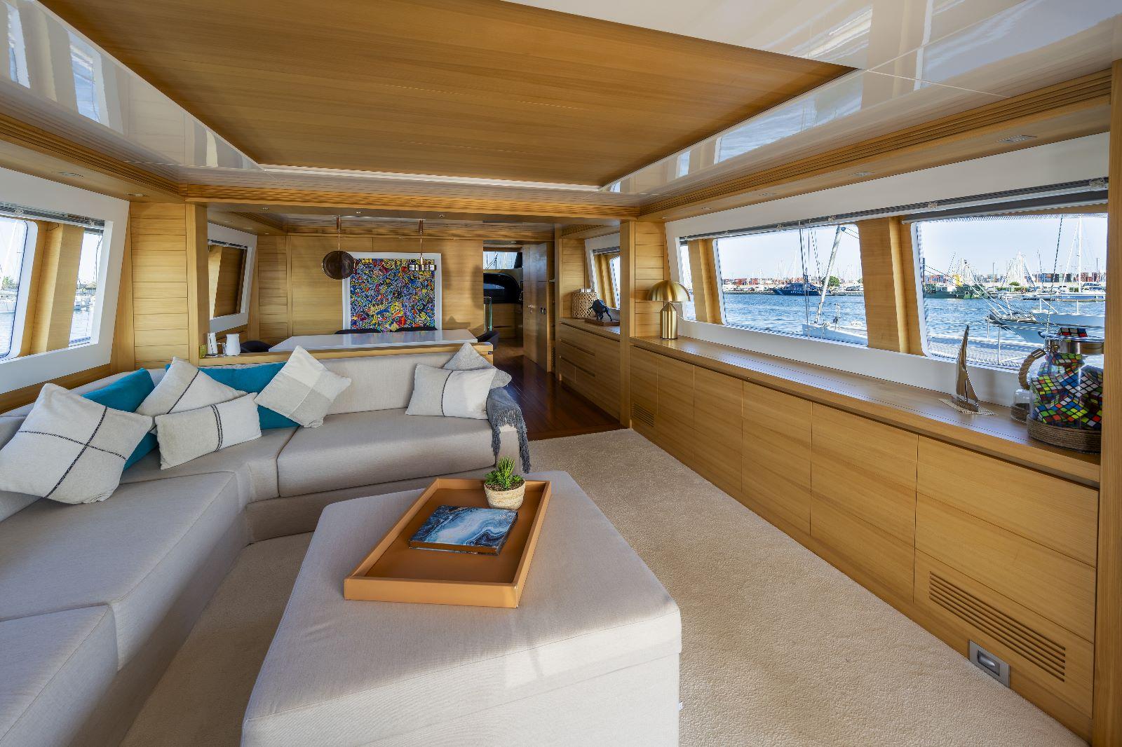 Luxurious interior of 2011 Maiora 27 yacht with elegant seating and panoramic windows.