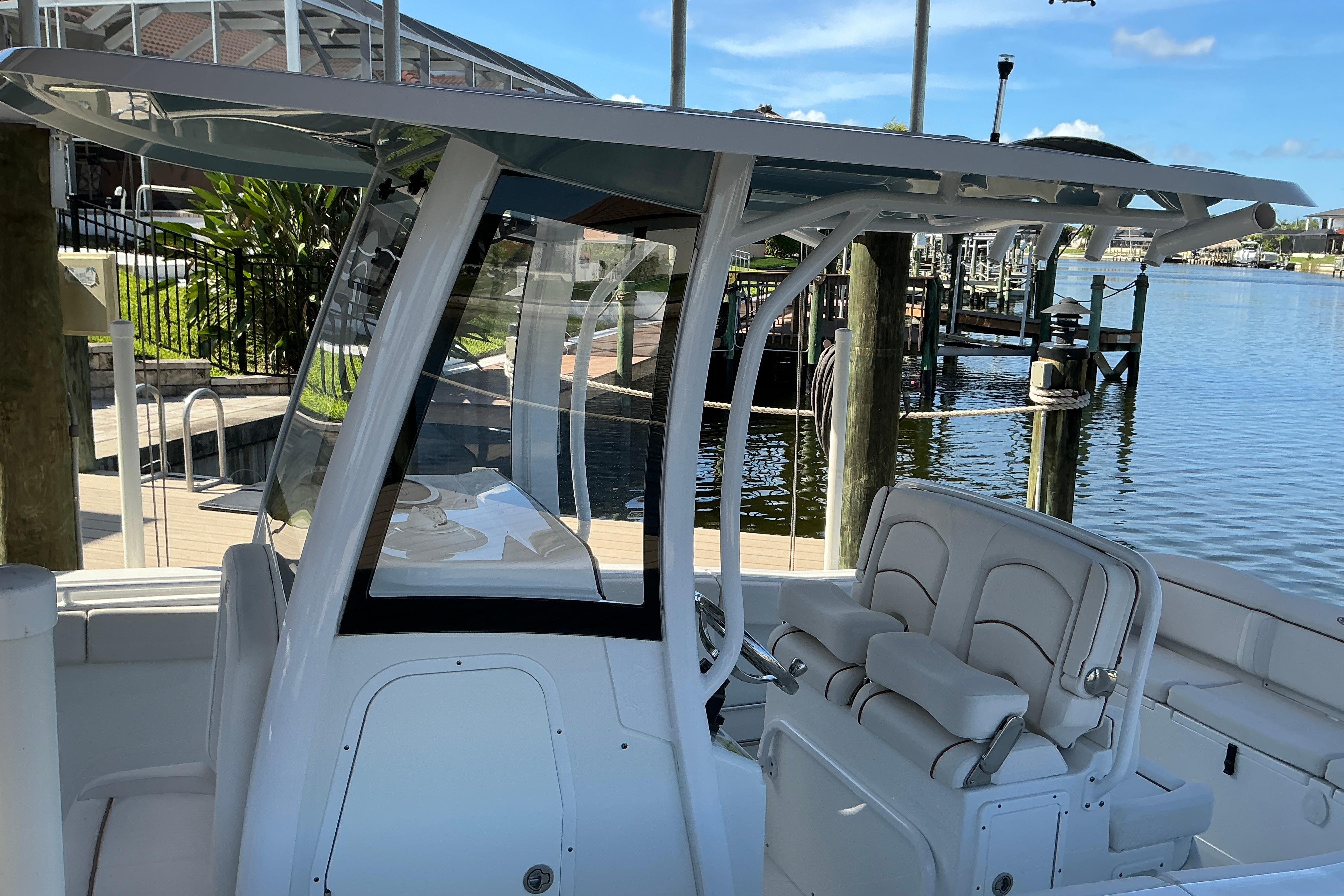2019 Sea Hunt Ultra 255 SE boat docked, featuring sleek seating and modern design.